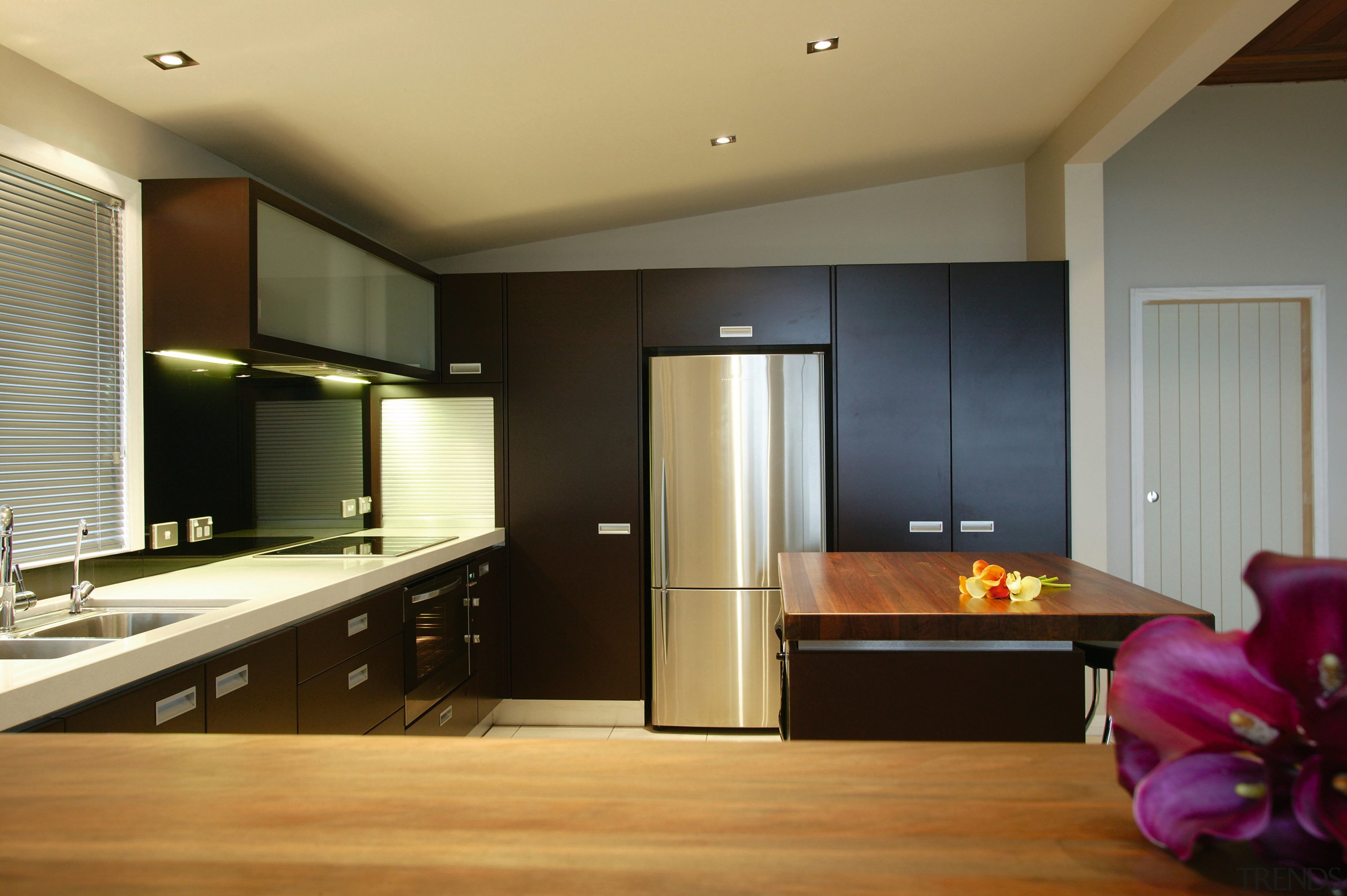 Kitchen with dark brown cabinetry, white benchtops with cabinetry, ceiling, countertop, floor, flooring, hardwood, interior design, kitchen, lighting, real estate, room, wood flooring