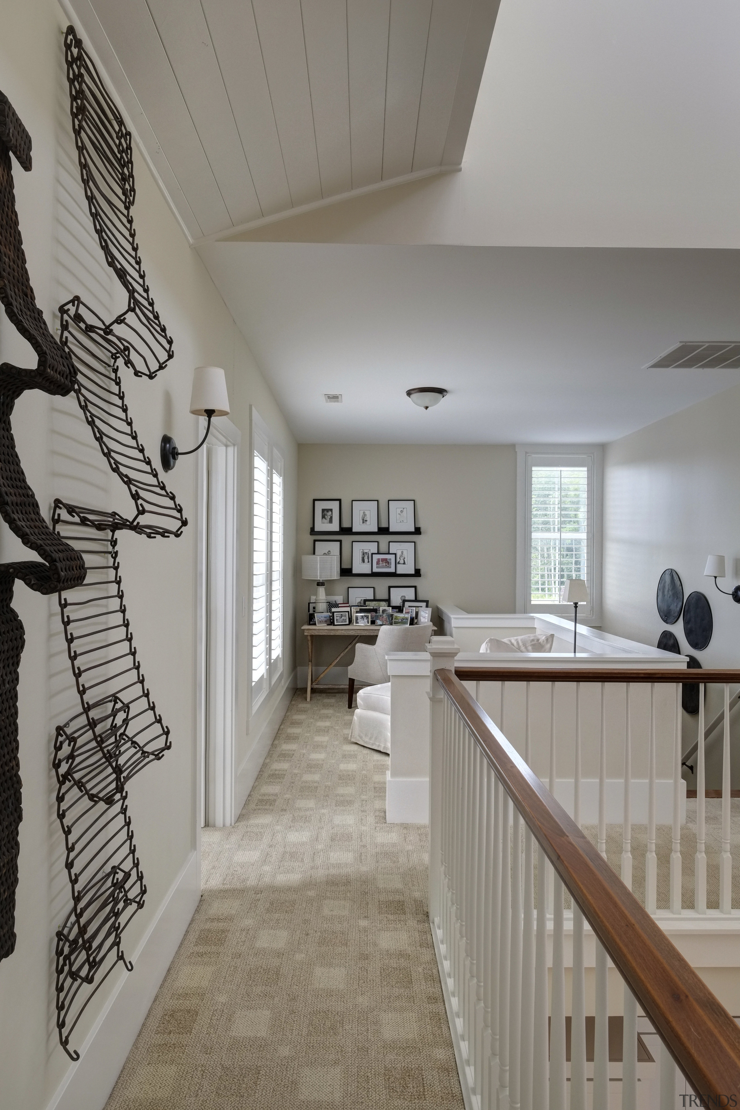 An agricultural conveyor belt adorns the wall leading architecture, ceiling, daylighting, estate, floor, flooring, handrail, home, house, interior design, real estate, room, stairs, wall, wood, gray