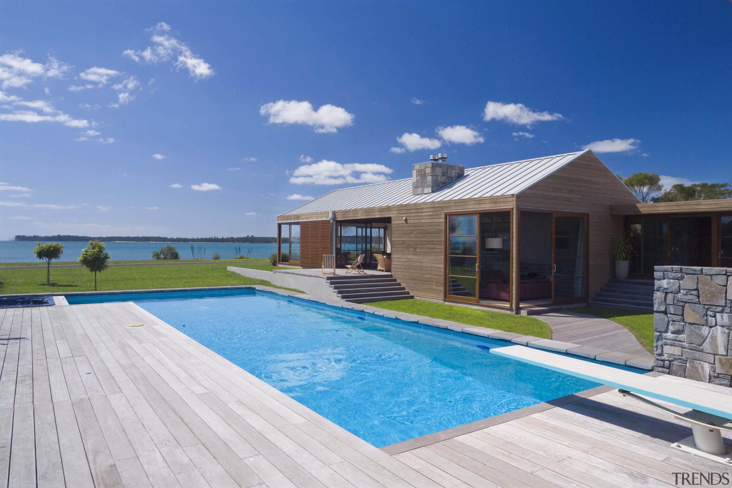 This coastal holiday home draws on rural forms estate, home, house, leisure, property, real estate, resort, roof, sky, swimming pool, vacation, villa, teal