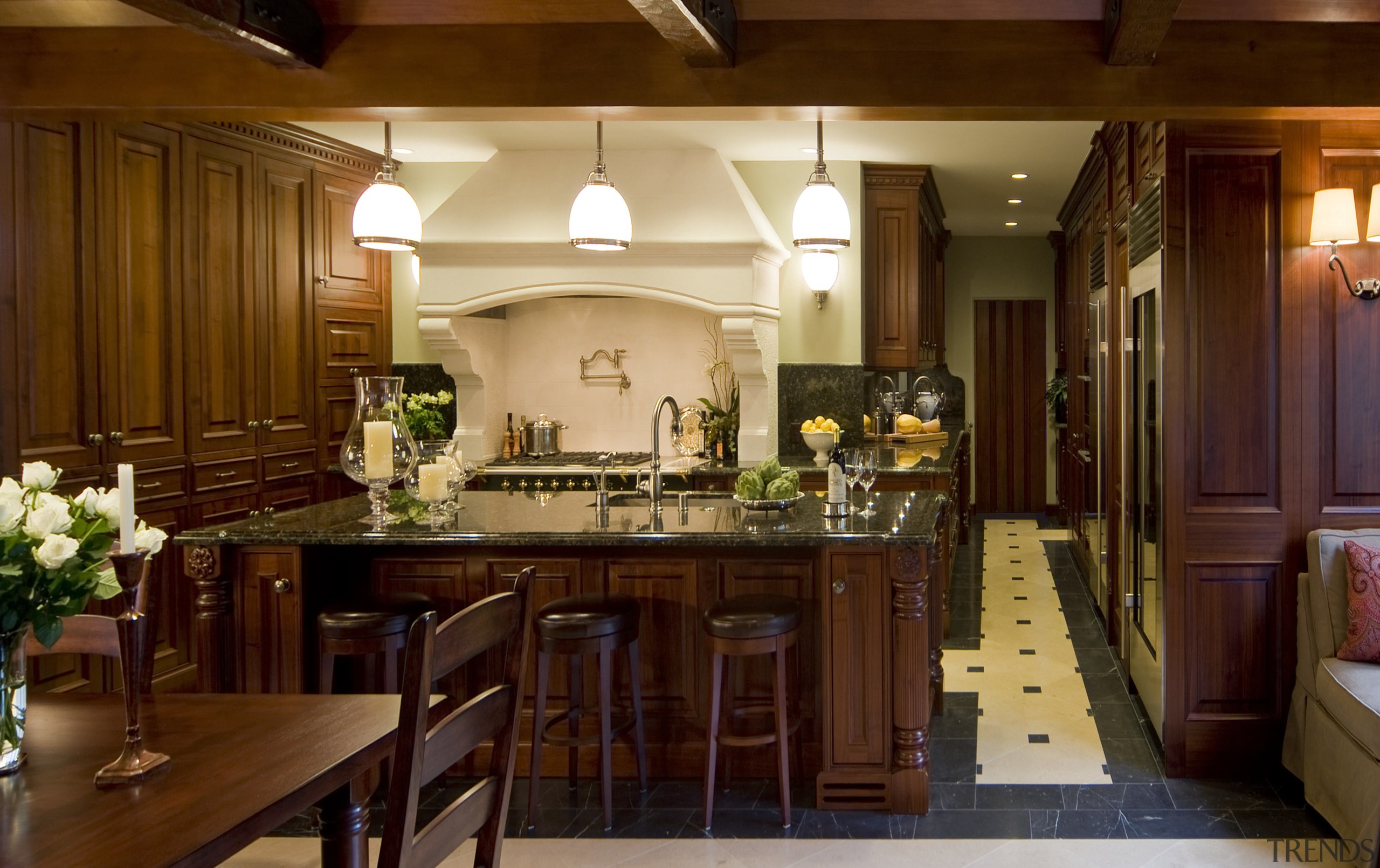 View of a traditional-styled kitchen which features dark-stained cabinetry, ceiling, countertop, cuisine classique, dining room, home, interior design, kitchen, room, red, brown