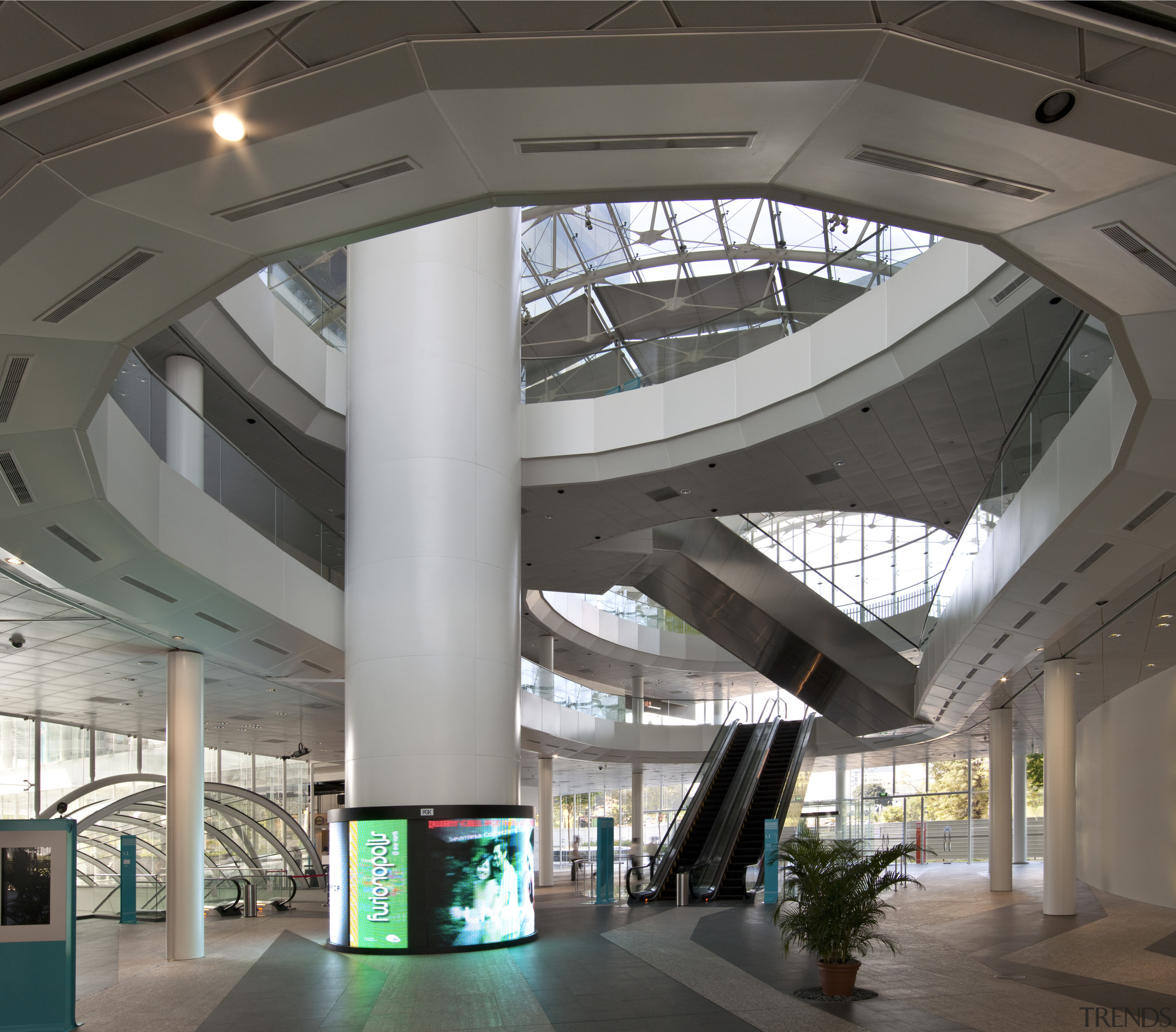 Interior view of the large public concourse between architecture, building, ceiling, convention center, daylighting, interior design, lobby, shopping mall, structure, gray, black