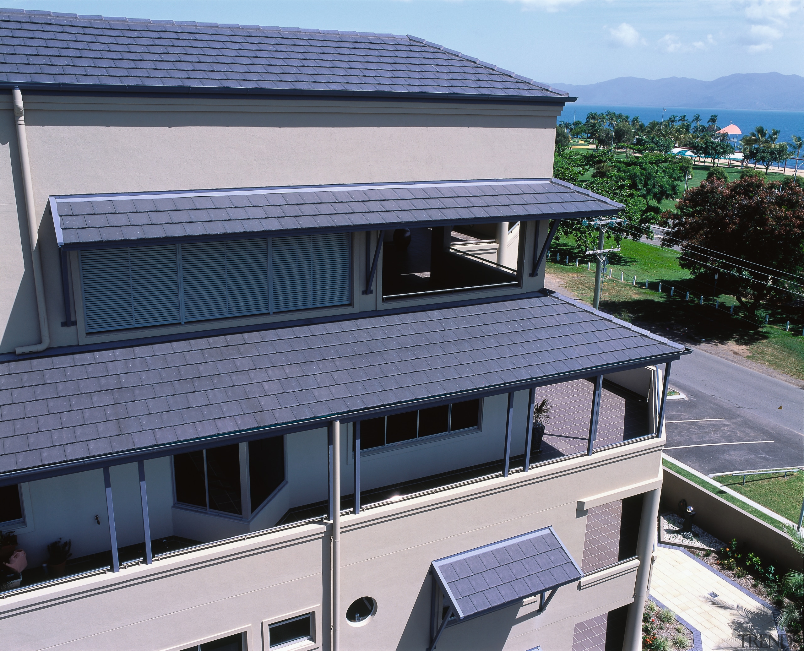 view of the overhanging eaves showing the csr architecture, building, condominium, daylighting, elevation, facade, home, house, property, real estate, residential area, roof, siding, window, blue