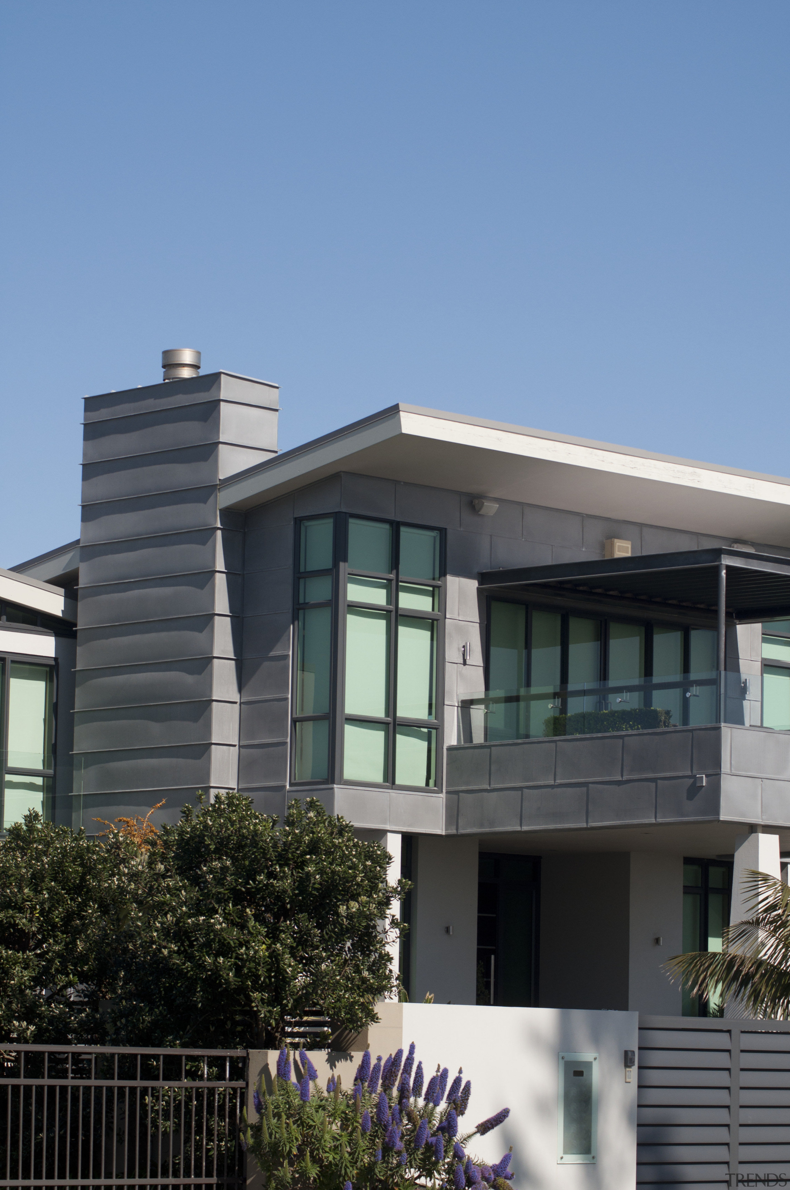 View of the roofing by Roofing Industries - architecture, building, corporate headquarters, elevation, facade, home, house, neighbourhood, property, real estate, residential area, roof, siding, sky, window, teal, black