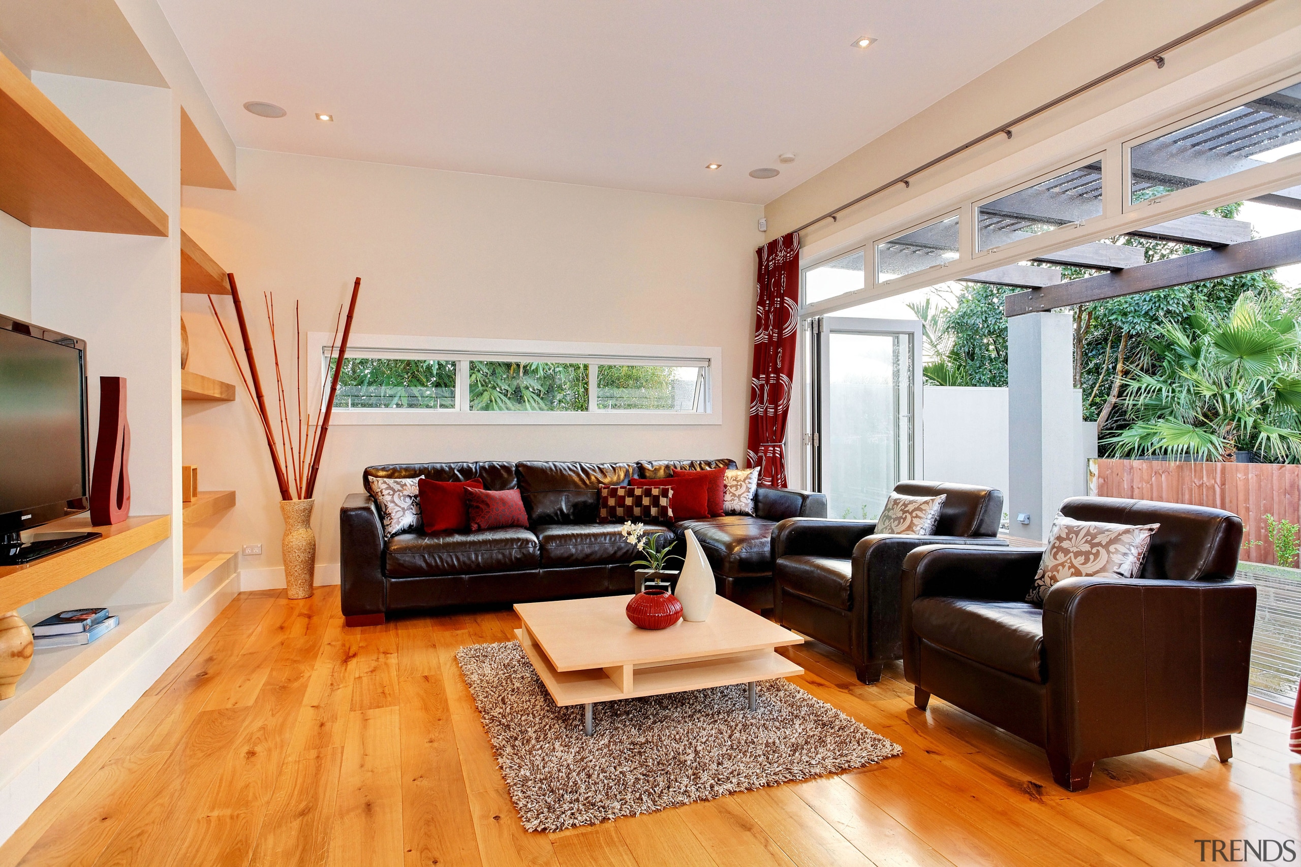 View of the living area which features under-floor ceiling, floor, hardwood, house, interior design, living room, property, real estate, room, gray, orange