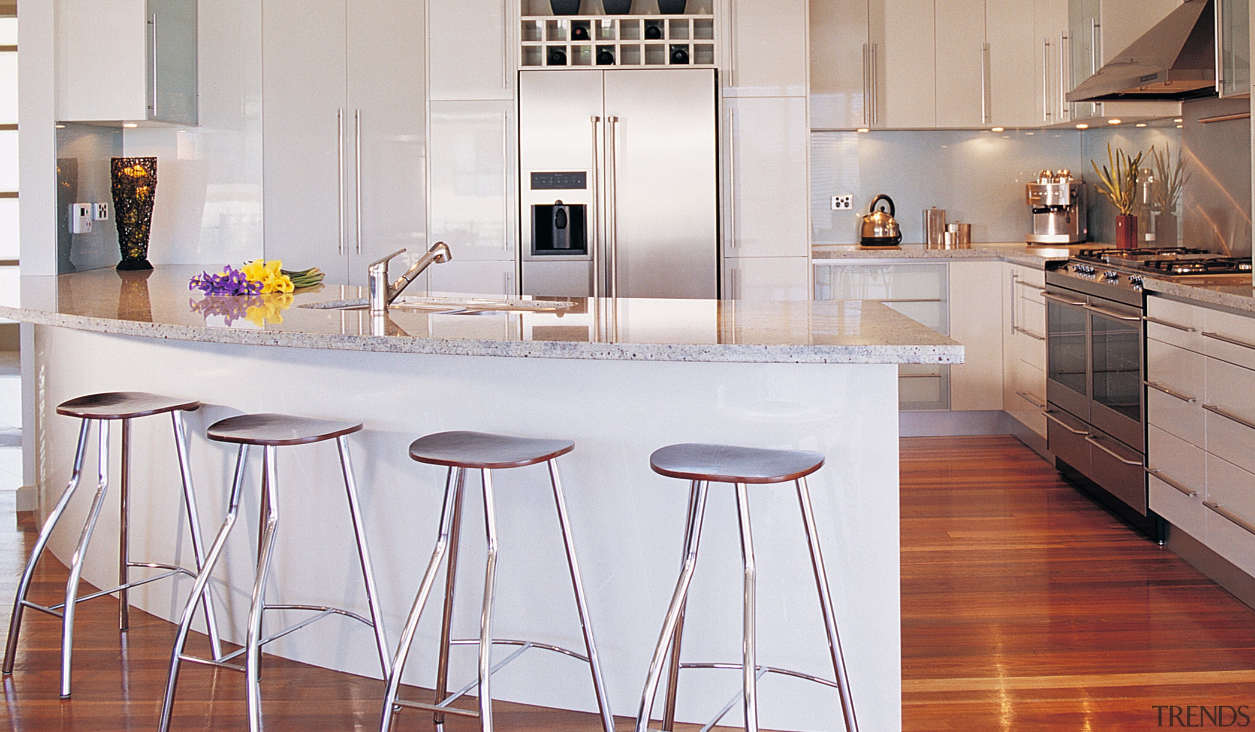 Kitchen with light coloured cabinetry, granite benchtop, curved cabinetry, countertop, cuisine classique, floor, flooring, furniture, hardwood, interior design, kitchen, laminate flooring, room, table, wood flooring, gray, white