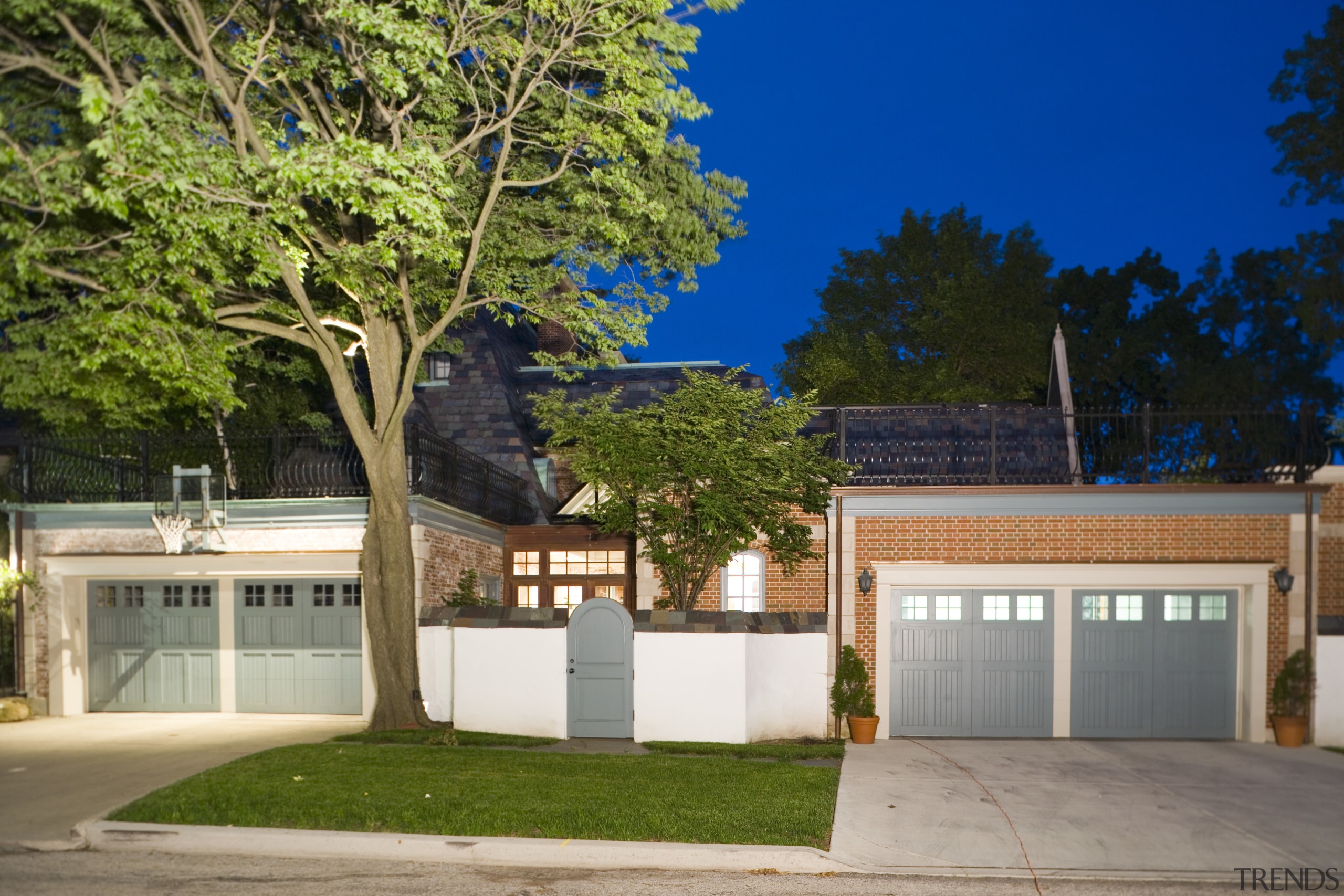 An exterior view of the entrance way to architecture, estate, facade, home, house, property, real estate, residential area, tree, brown