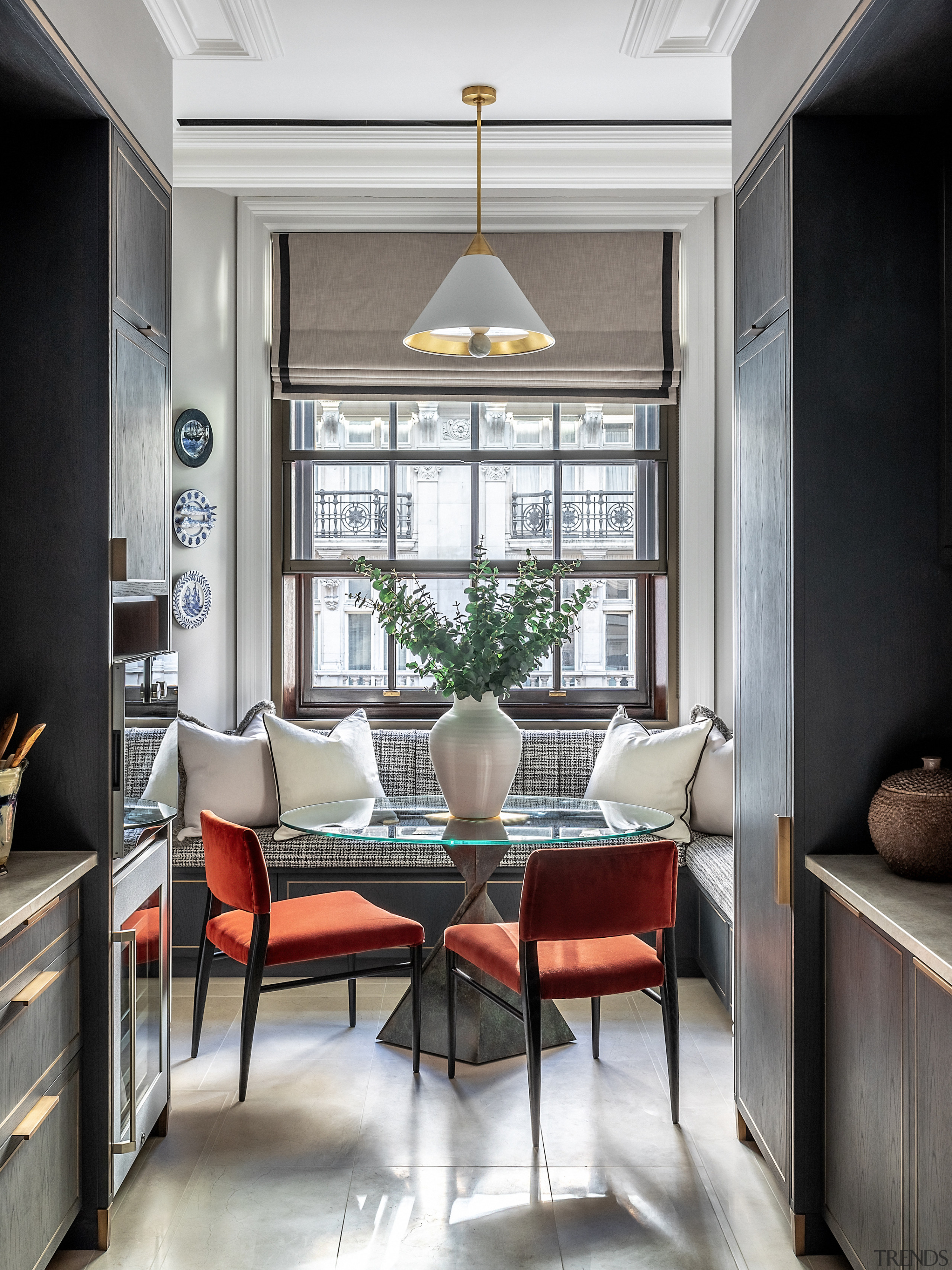 The kitchen area features a sculptural table of 