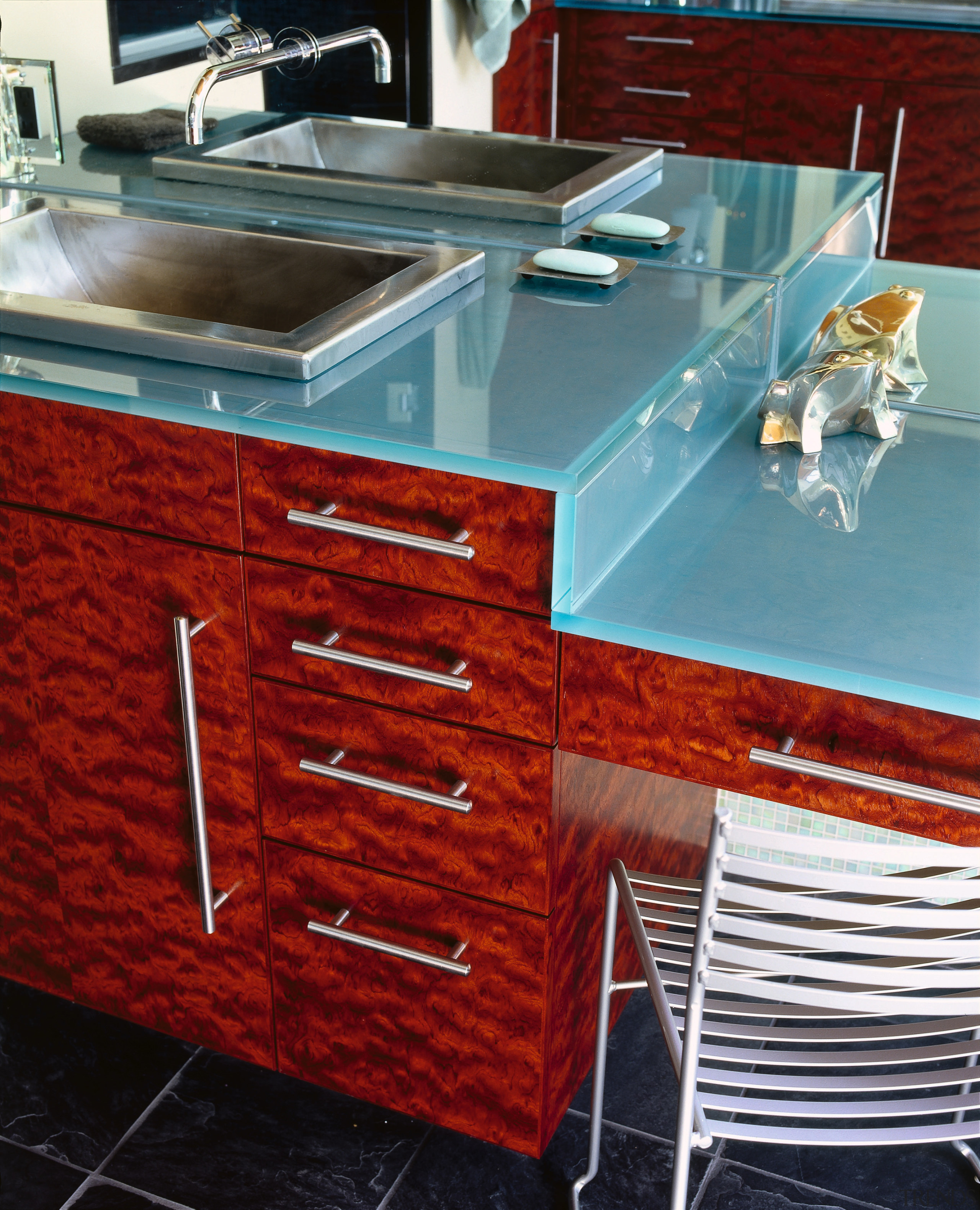 View of this vanity unit - View of cabinetry, chest of drawers, countertop, drawer, floor, flooring, furniture, hardwood, kitchen, kitchen stove, room, sink, tile, wood stain, red
