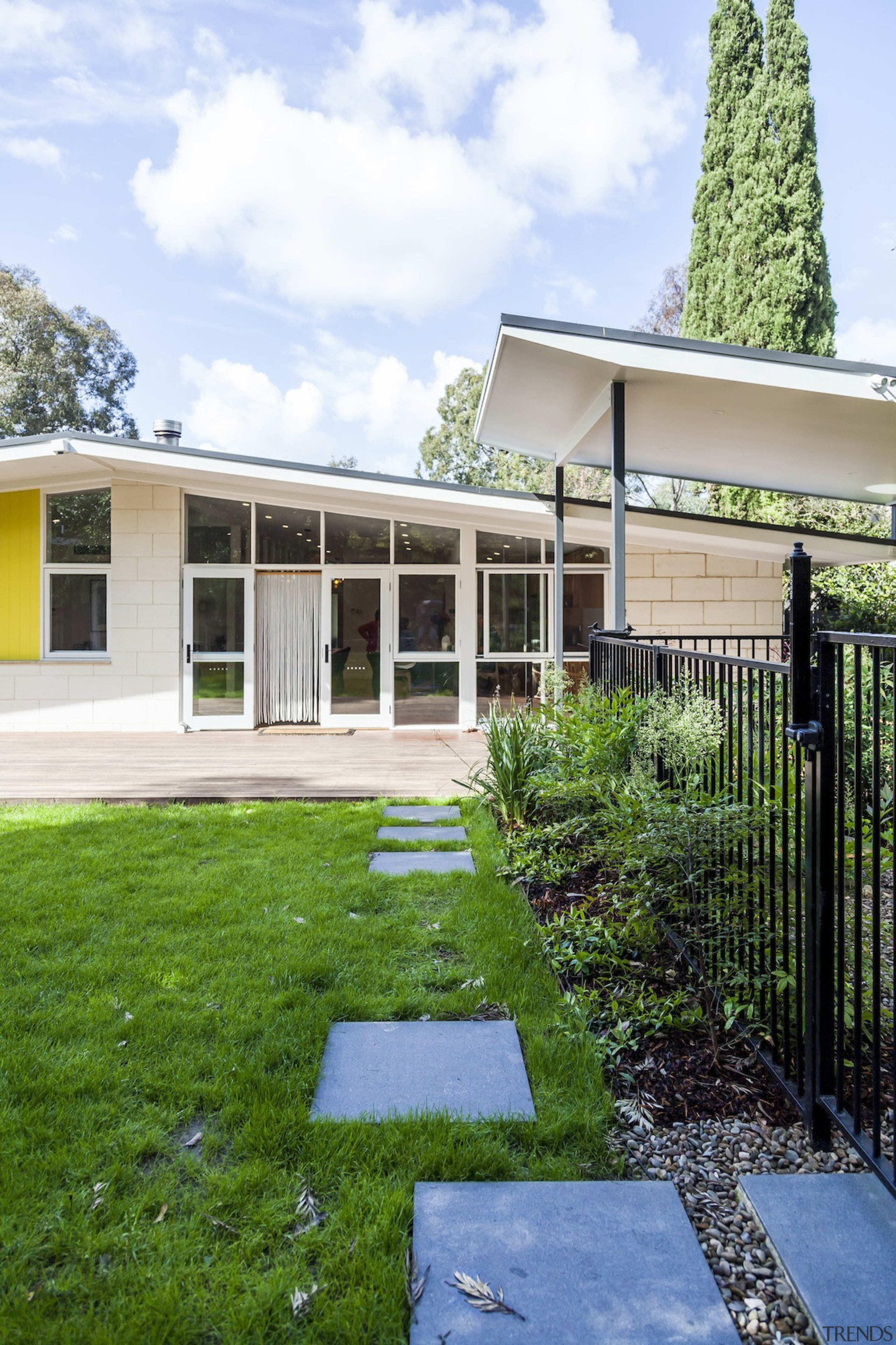 A large overhanging roof means shade during the architecture, backyard, cottage, estate, facade, grass, home, house, outdoor structure, property, real estate, residential area, yard, white