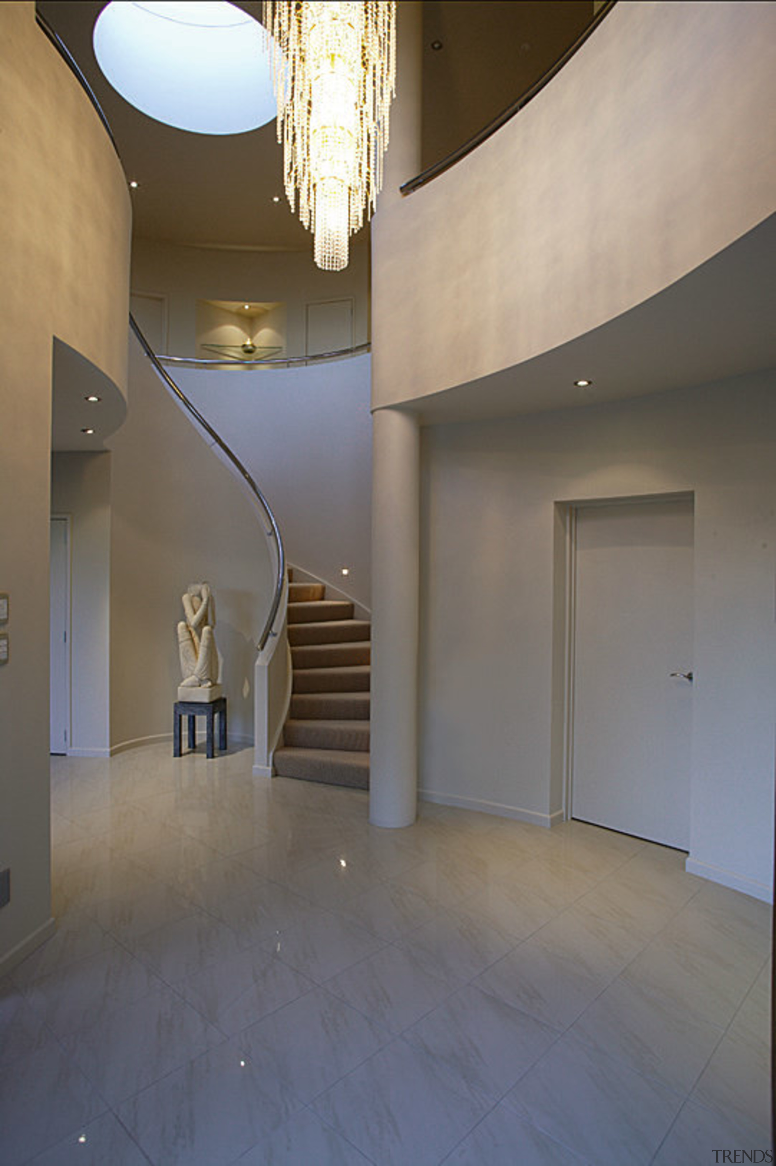 A overview of the curved staircase whch leads apartment, architecture, ceiling, daylighting, estate, floor, flooring, home, house, interior design, lobby, real estate, stairs, tourist attraction, wall, window, gray