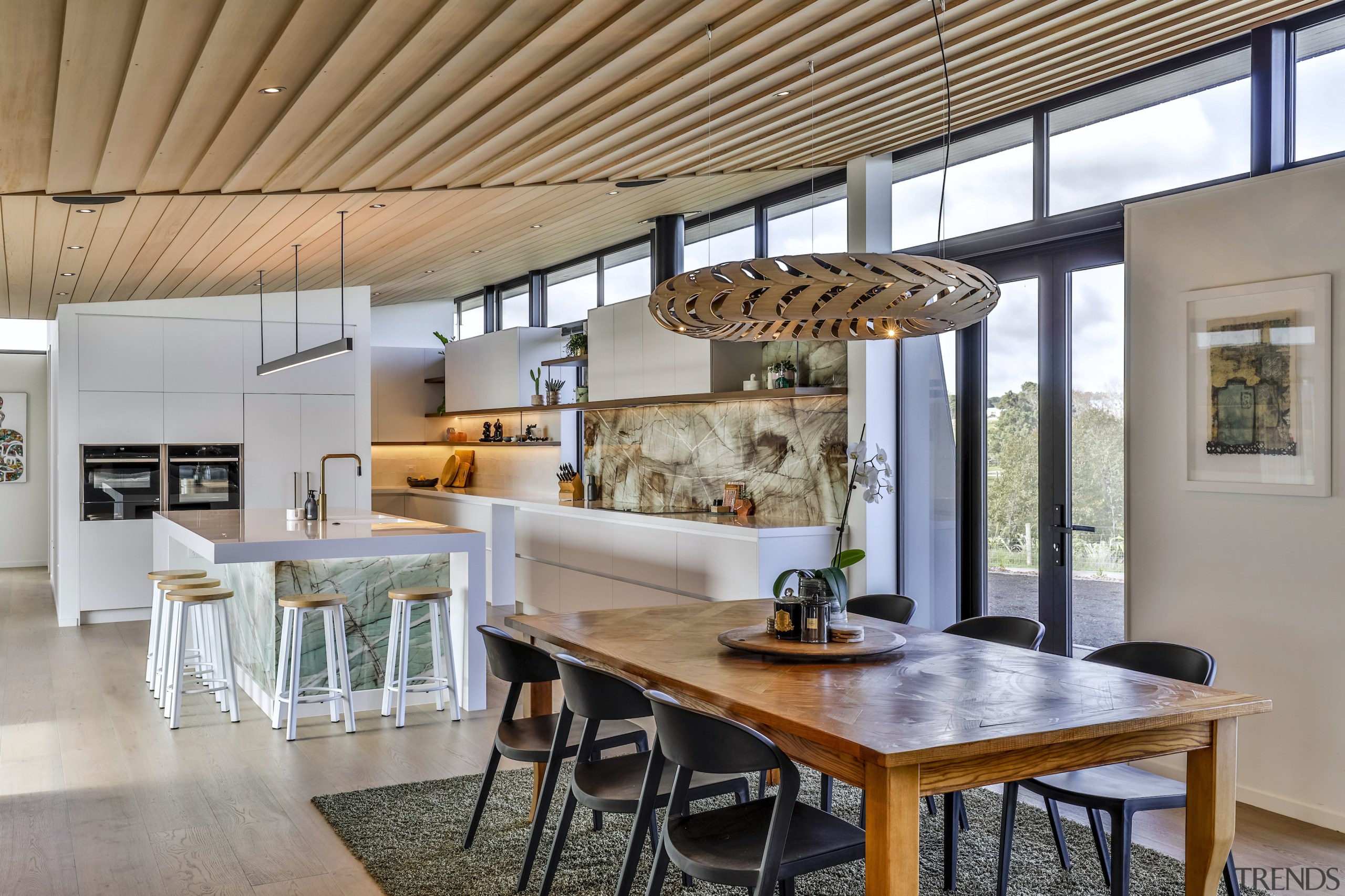 The contemporary pendant over the dining table echoes 