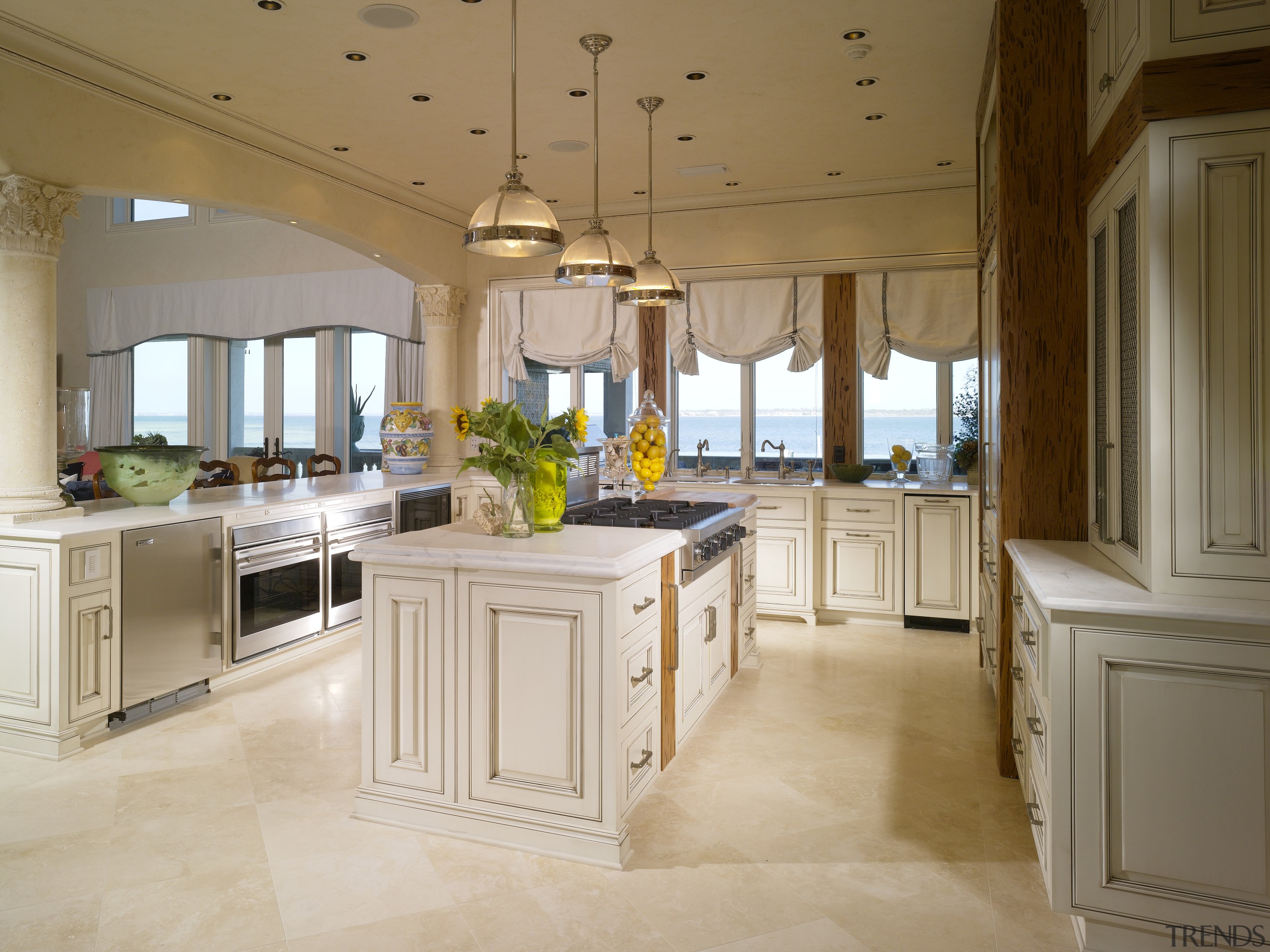 View of the kitchen which features an island cabinetry, ceiling, countertop, cuisine classique, estate, floor, flooring, interior design, kitchen, room, brown, gray
