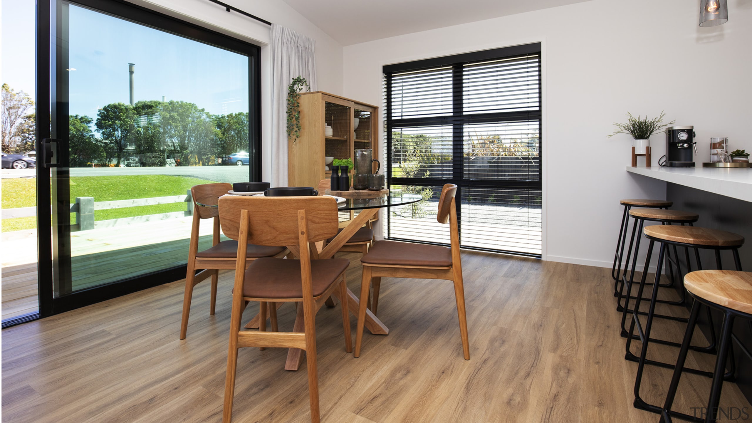 A wall of black-framed floor-to-ceiling stacker doors opens 