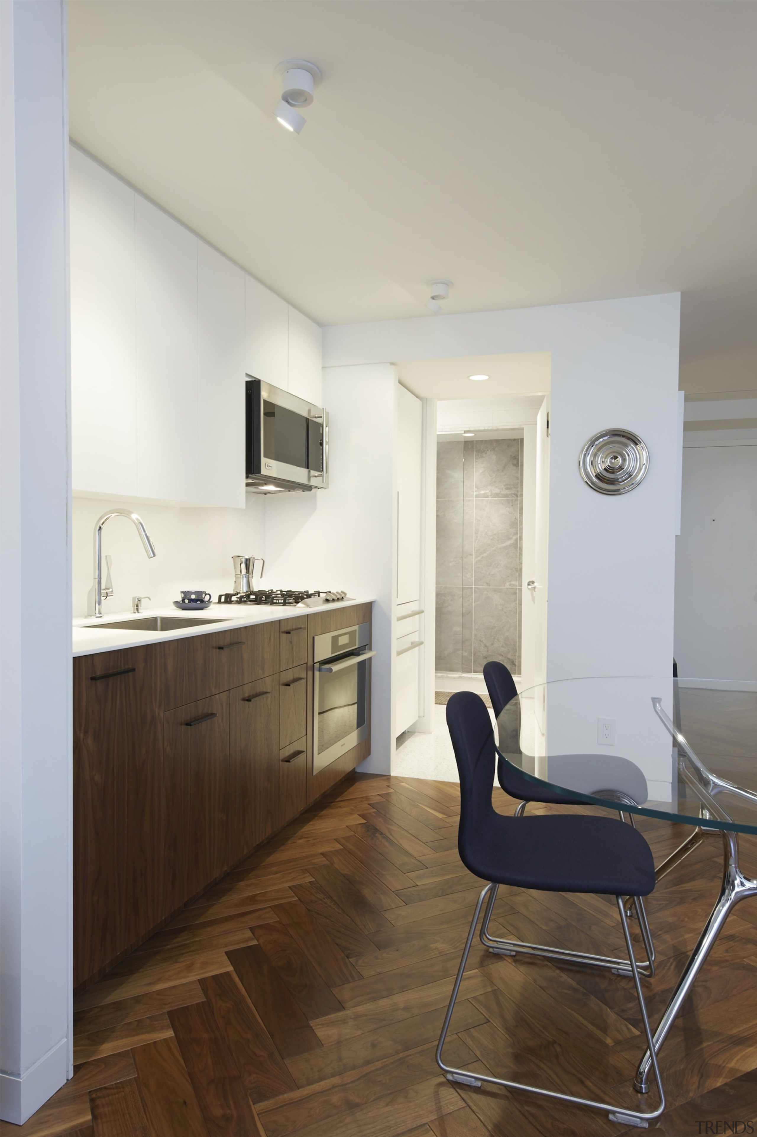 The fridge sits adjacent to the bathroom area apartment, architecture, ceiling, daylighting, floor, flooring, home, house, interior design, kitchen, real estate, room, wood, wood flooring, gray, brown