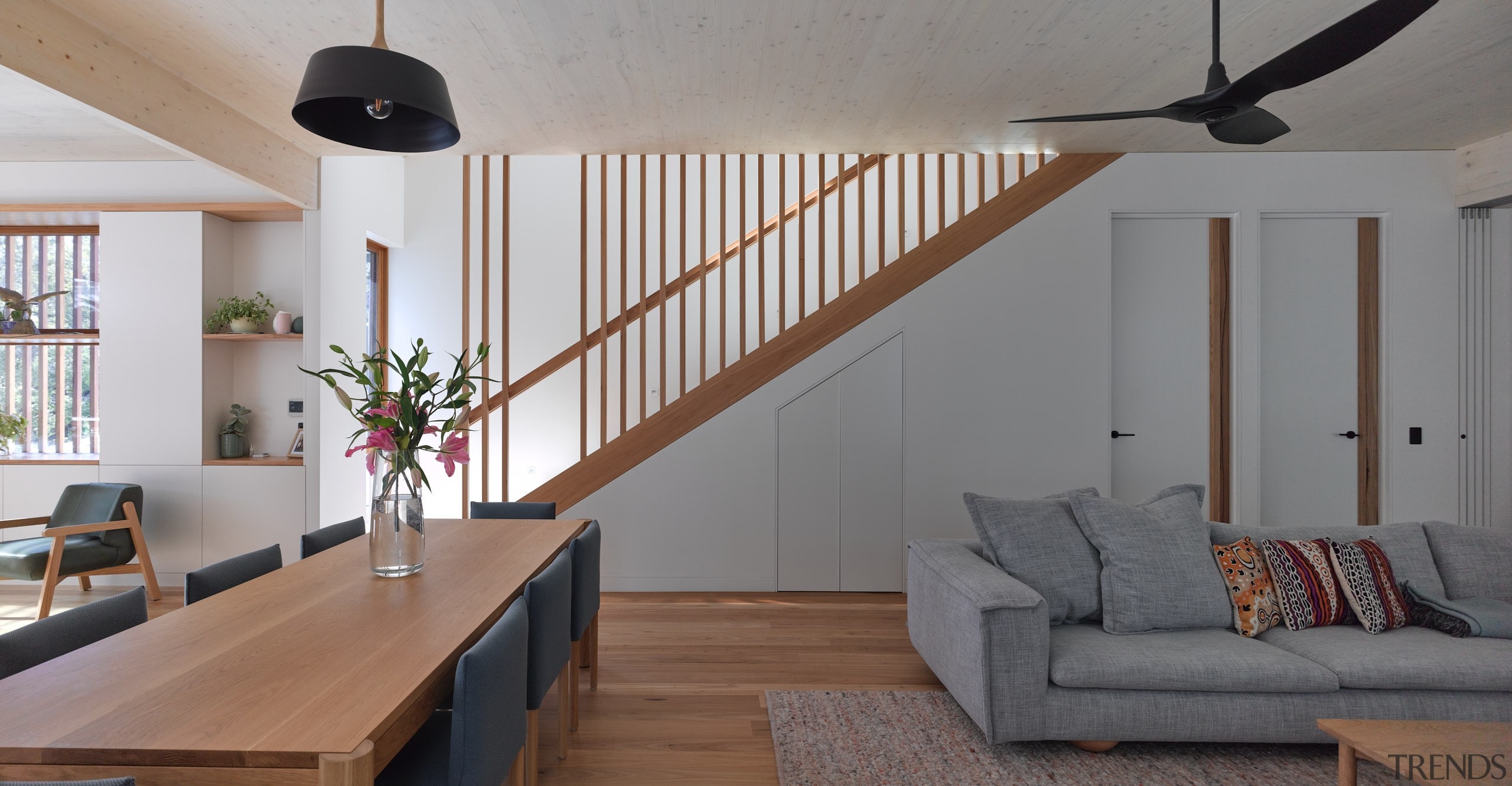 The dining and living area with stairs leading 
