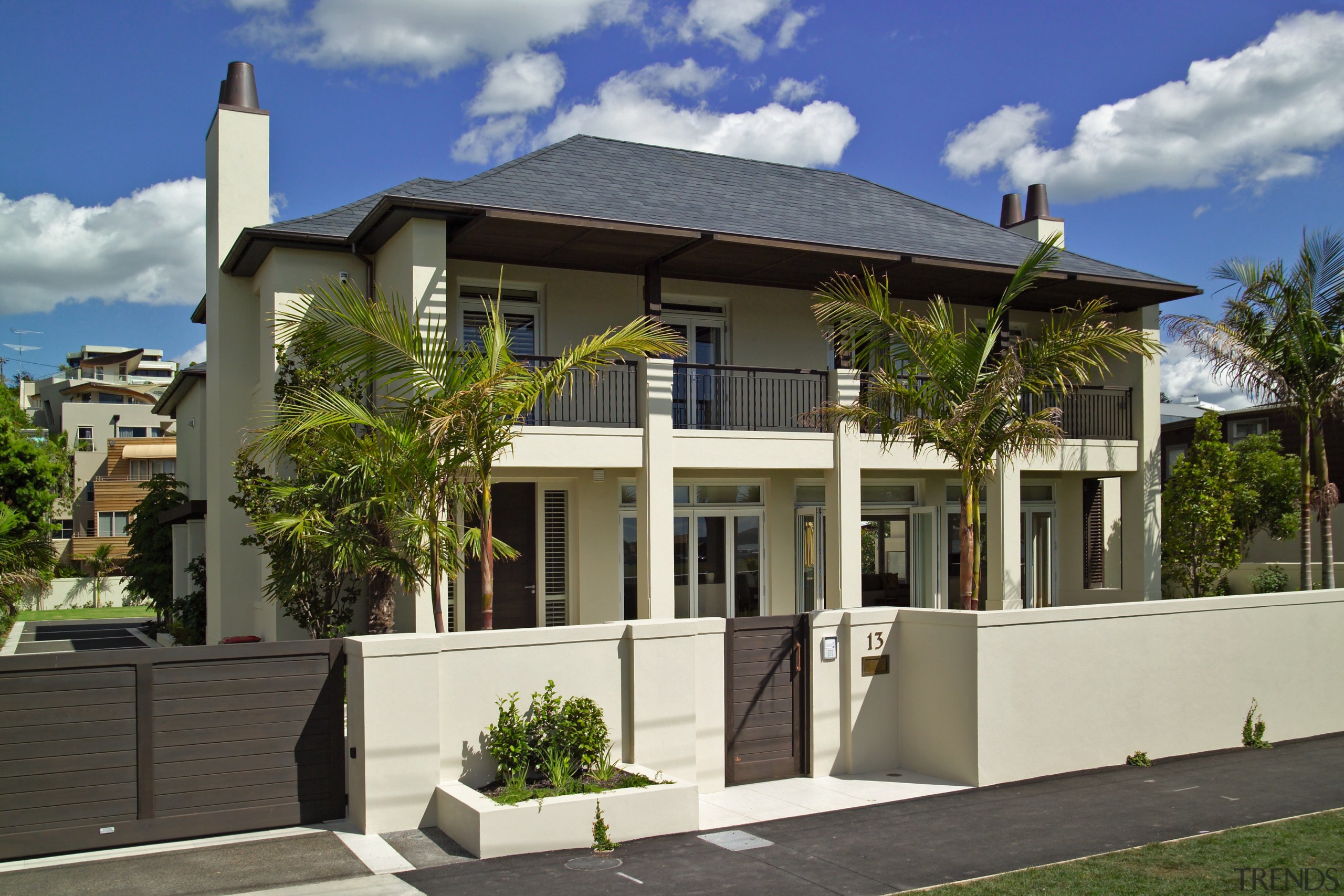 Exterior of two level masonry home with pillars, apartment, building, condominium, elevation, estate, facade, home, house, mansion, mixed use, neighbourhood, property, real estate, residential area, villa