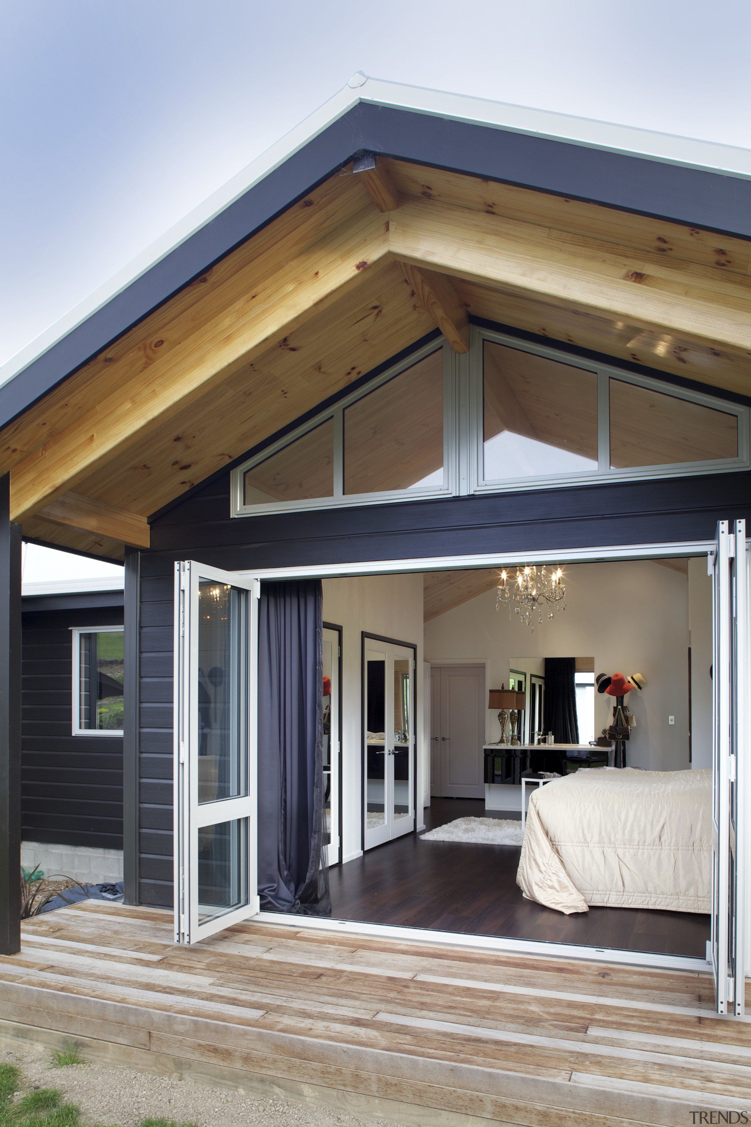 This master bedroom suite continues the light, airy daylighting, facade, home, house, porch, property, real estate, roof, siding, window