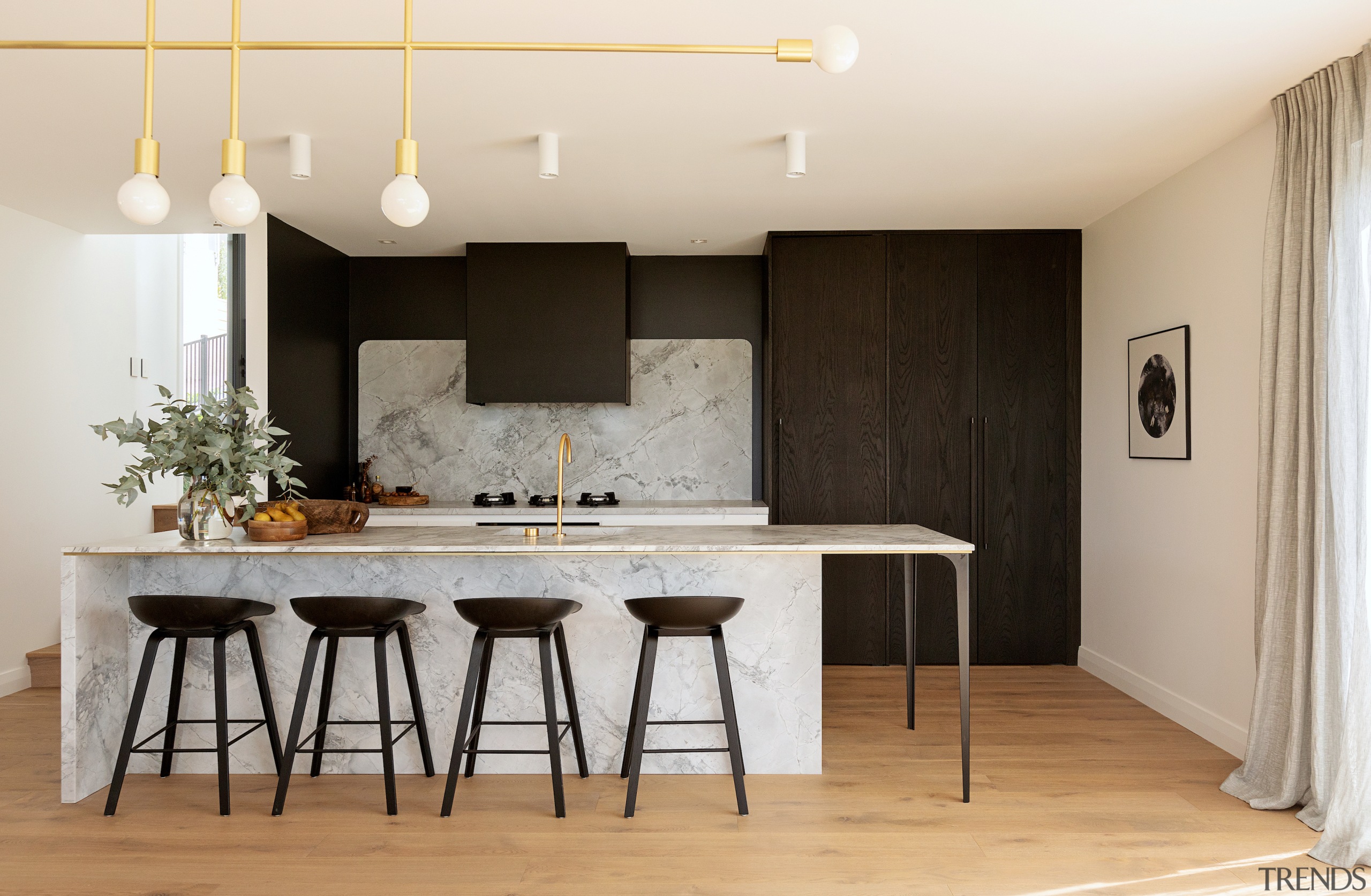 The tall cabinetry and dark feature wall were 