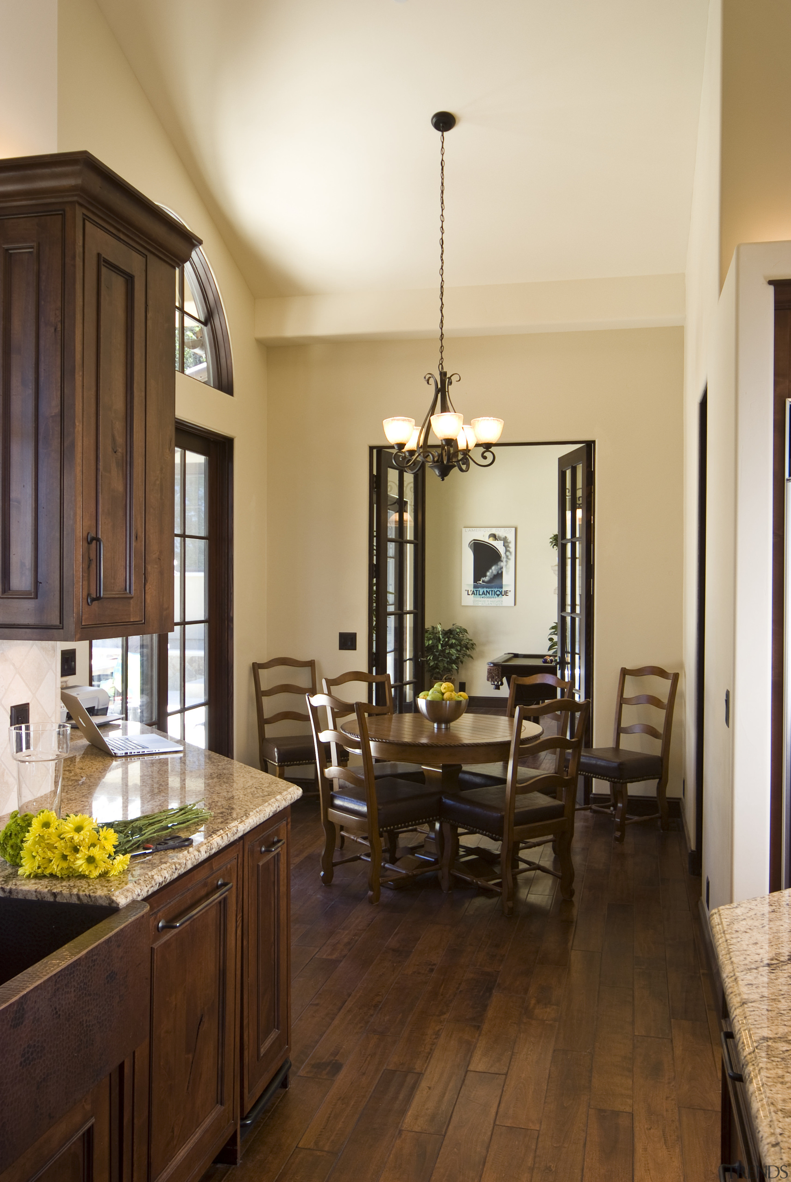 View of a Tuscan-styled kitchen which features dark-stained ceiling, countertop, dining room, floor, flooring, hardwood, home, interior design, kitchen, living room, real estate, room, wood, wood flooring, brown