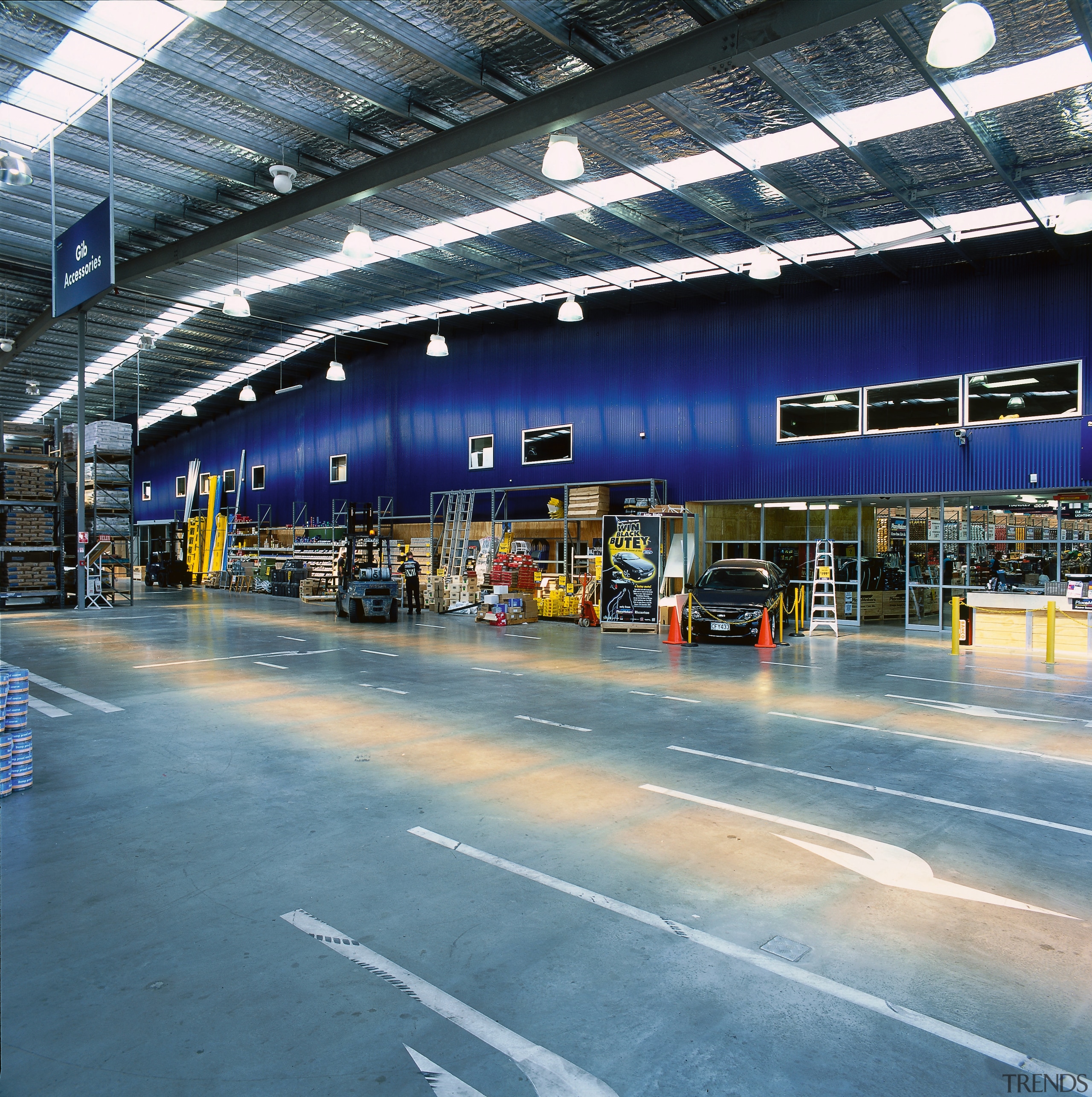 View of interior of Placemakers store with expansive airport terminal, car, metropolitan area, sky, structure, teal