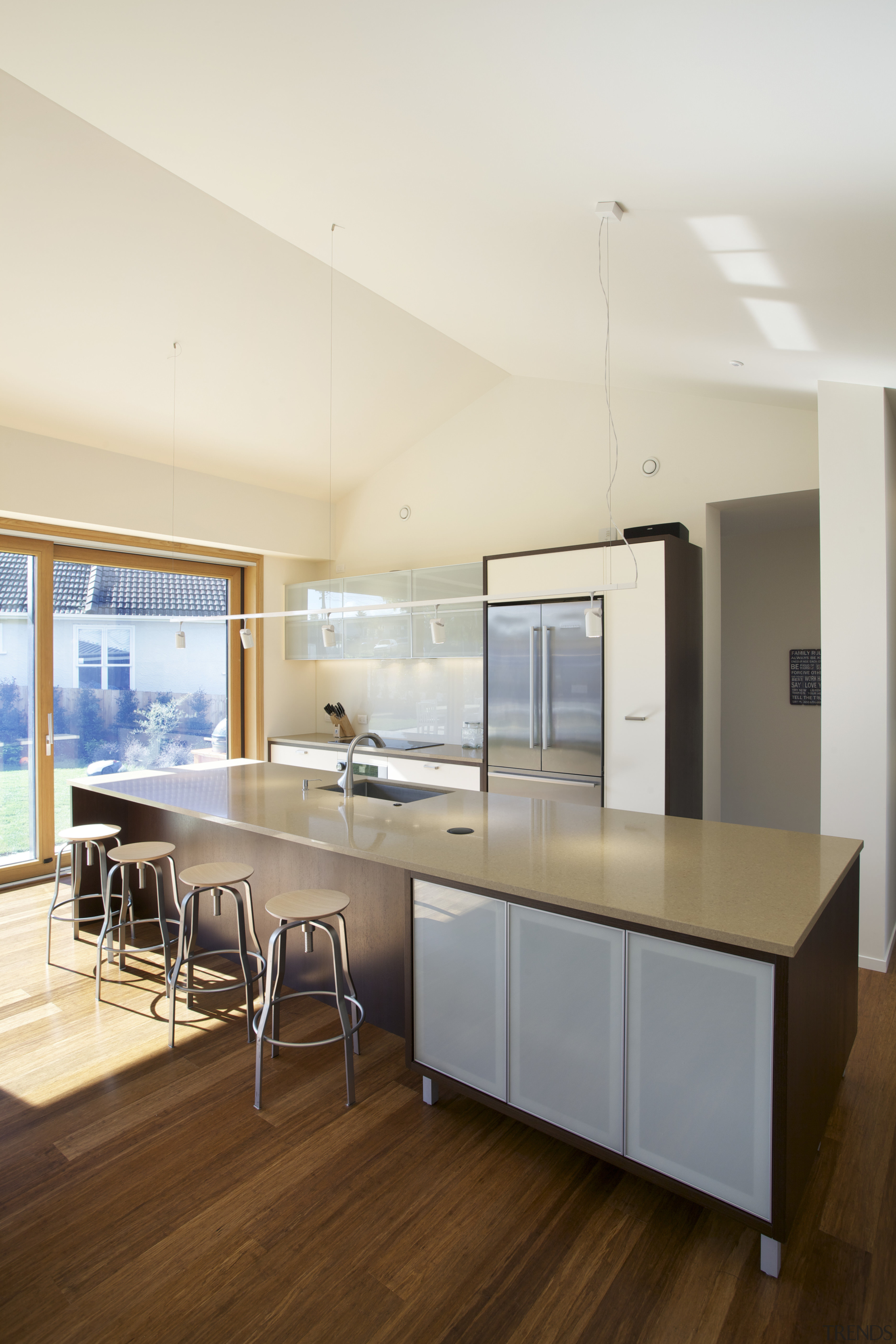 In this passive house, the kitchen, and the architecture, ceiling, countertop, floor, hardwood, house, interior design, kitchen, real estate, wood flooring, white, brown
