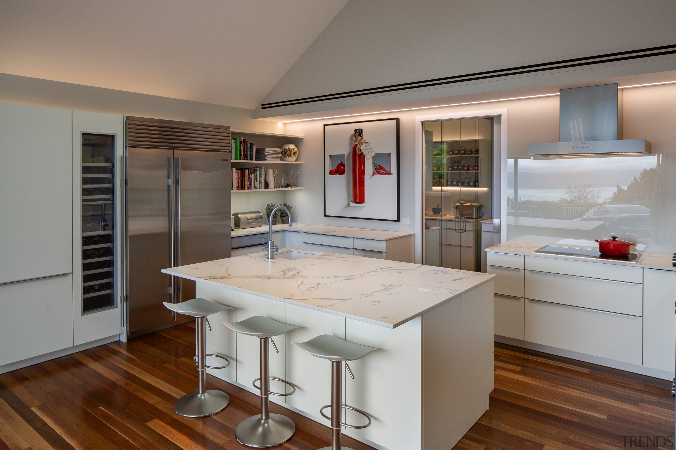 ​​​​​​​A glass splashback provides a degree of reflected architecture, building, cabinetry, ceiling, countertop, cuisine classique, cupboard, floor, furniture, hardwood, home, house, interior design, kitchen, kitchen stove, laminate flooring, loft, major appliance, material property, property, real estate, room, shelf, table, wood flooring, gray, brown