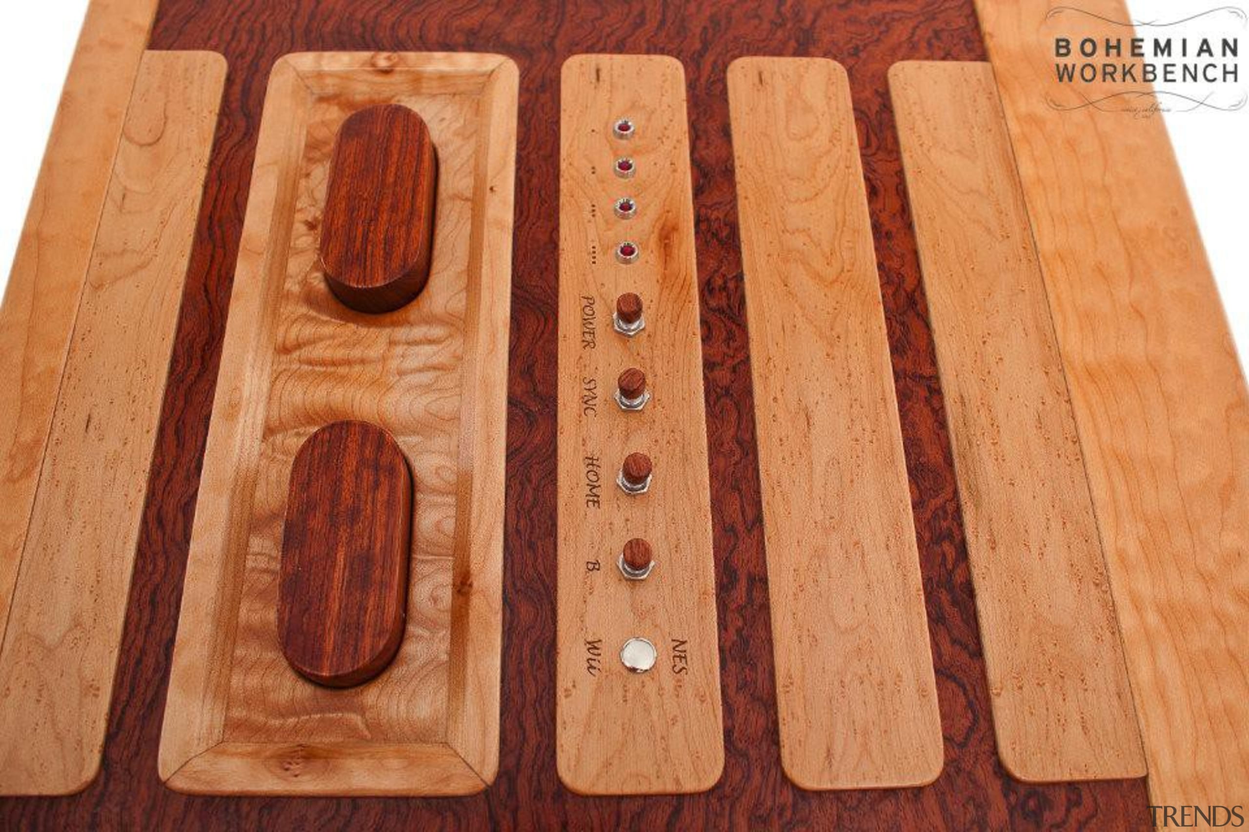 Game on! This retro-styled coffee table is a floor, flooring, hardwood, lumber, wood, wood stain, orange, red