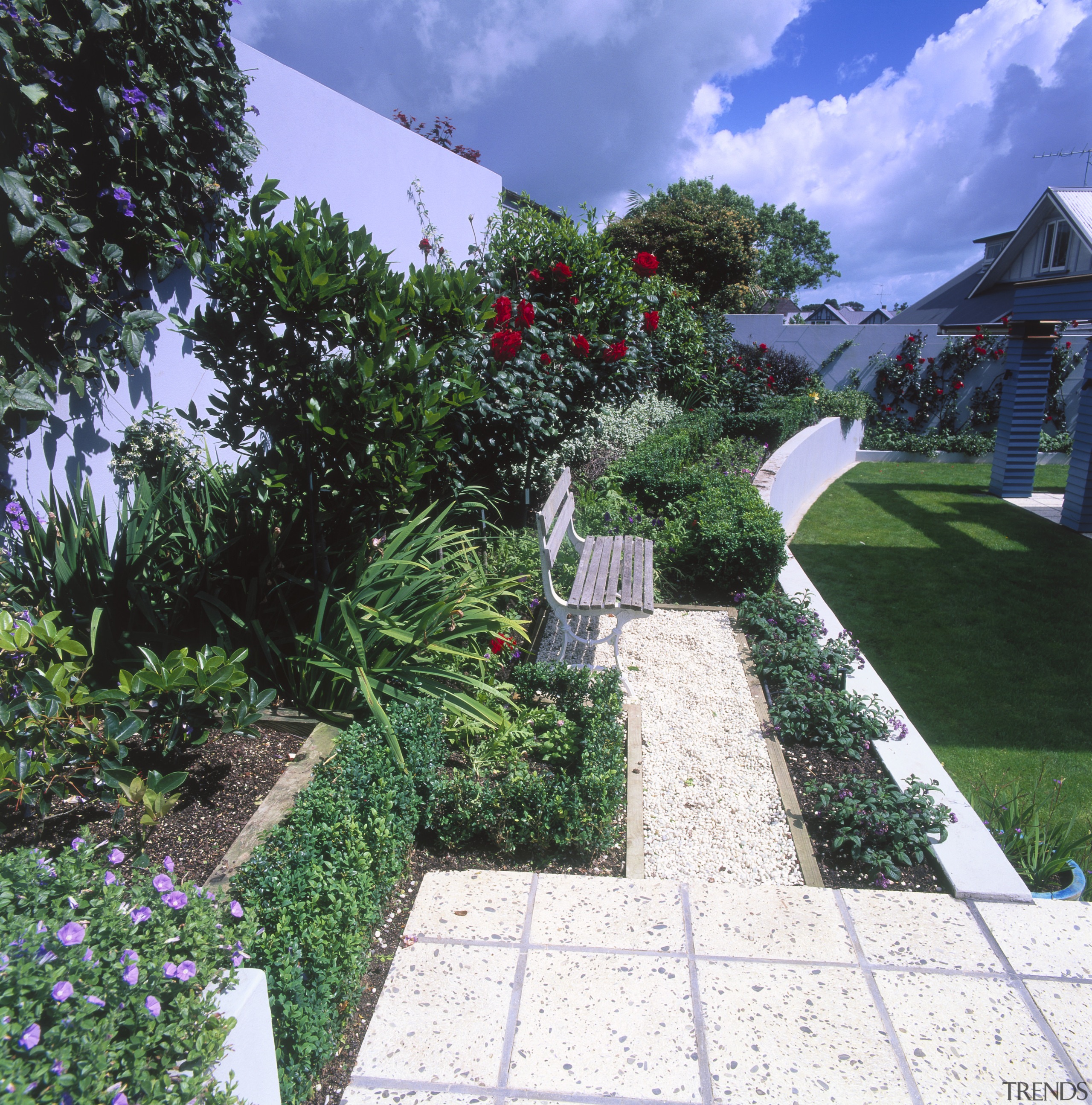 An exterior view of the garden area, pavers, backyard, estate, flower, garden, grass, home, house, landscape, landscaping, lawn, plant, property, real estate, shrub, tree, walkway, yard, blue