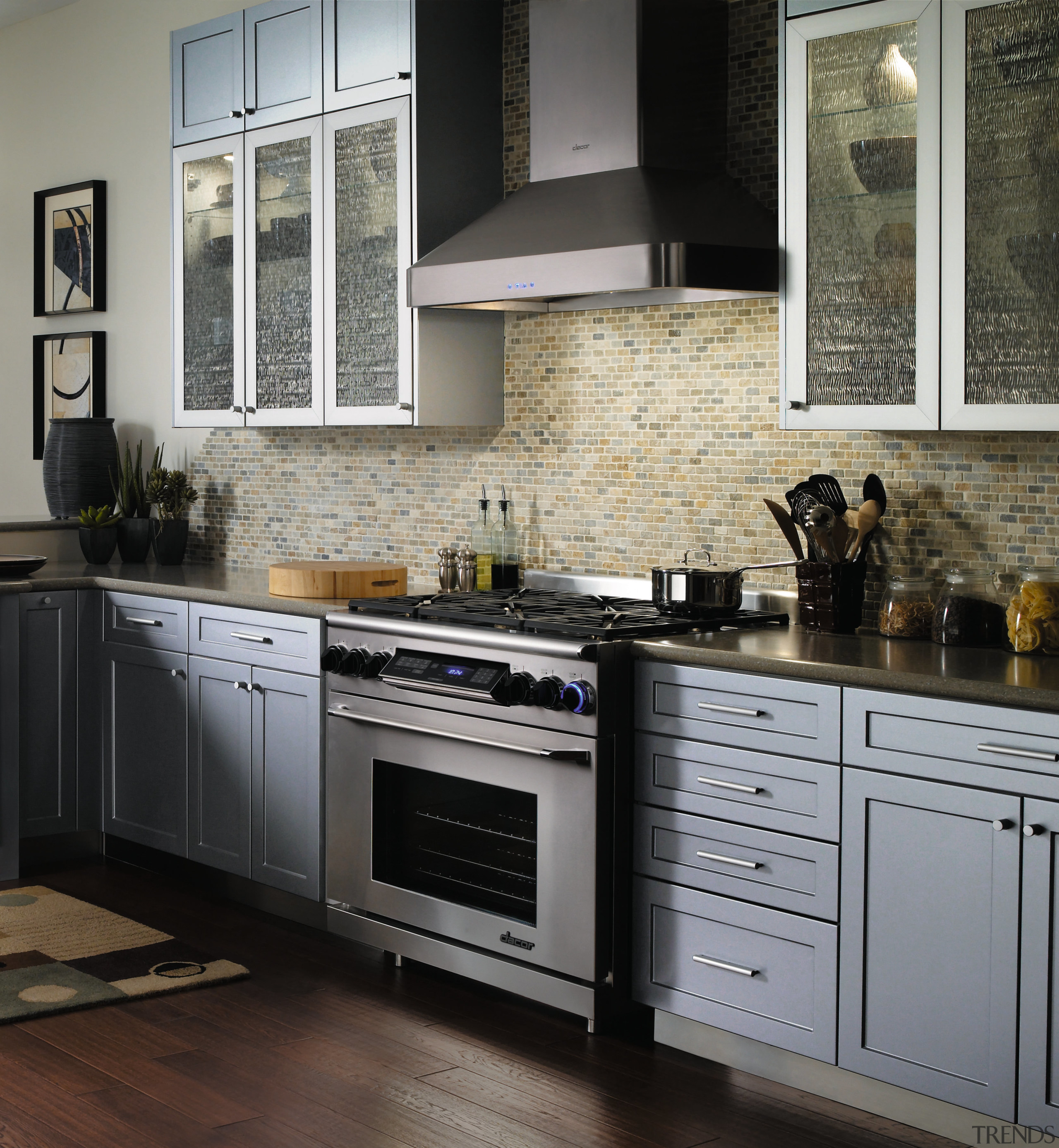 A view of this kitchen featuring grey timber cabinetry, countertop, cuisine classique, floor, flooring, hardwood, home appliance, interior design, kitchen, kitchen appliance, kitchen stove, room, tile, wood flooring, gray, black