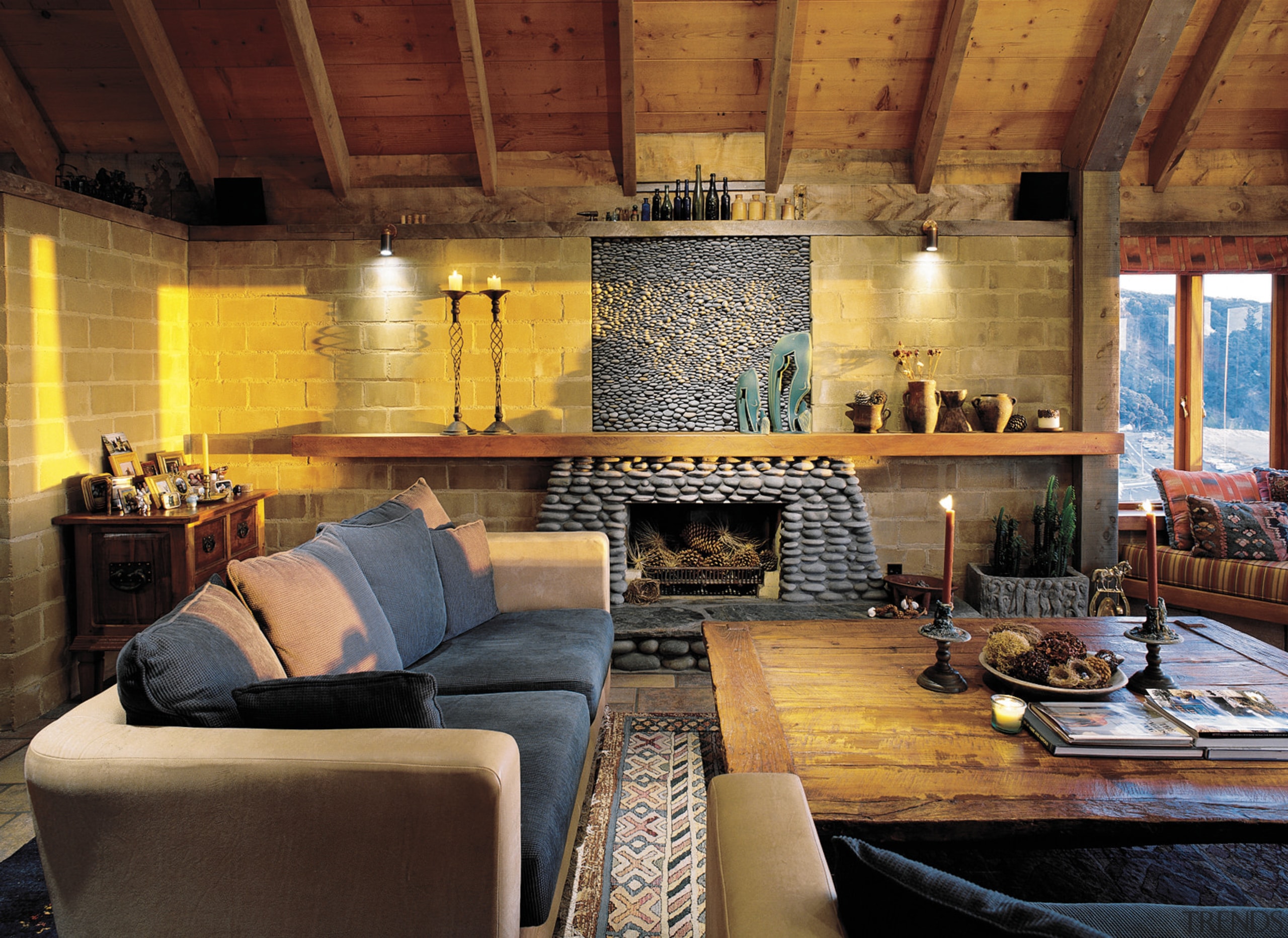 An interior view of the living area featuring ceiling, fireplace, hearth, home, interior design, living room, real estate, room, wall, wood, brown