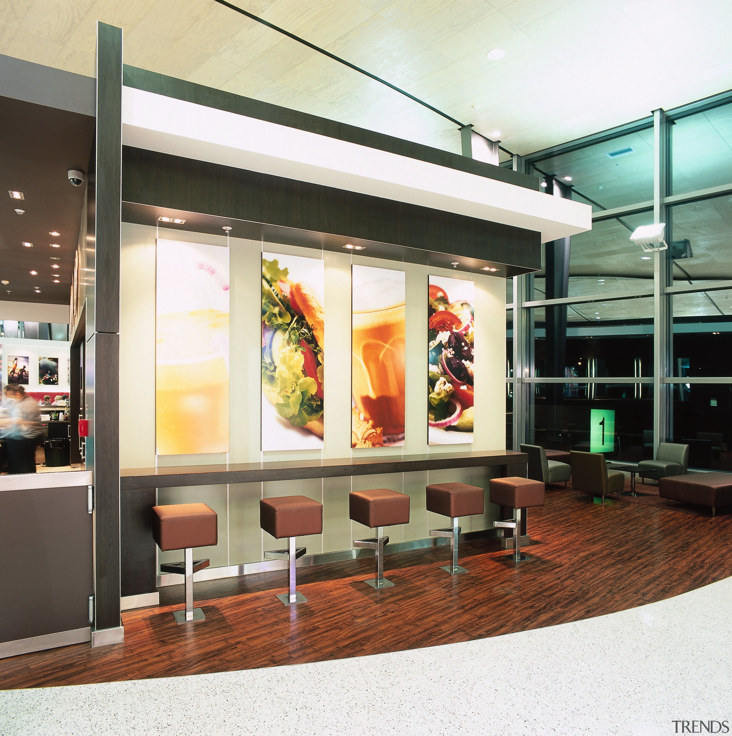 Seating area of food court with stools, bold interior design, white