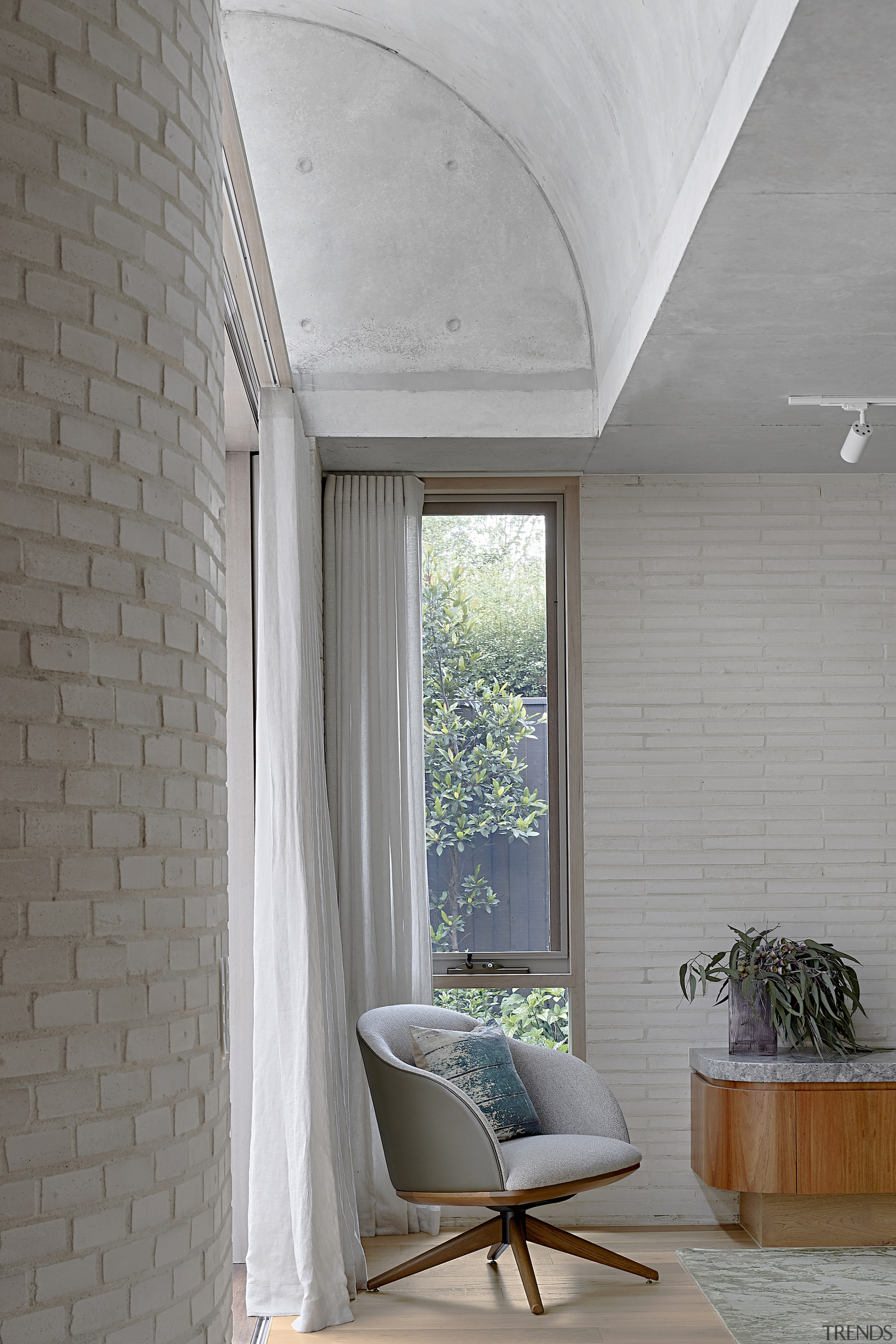 The curved brick wall that arcs through the 