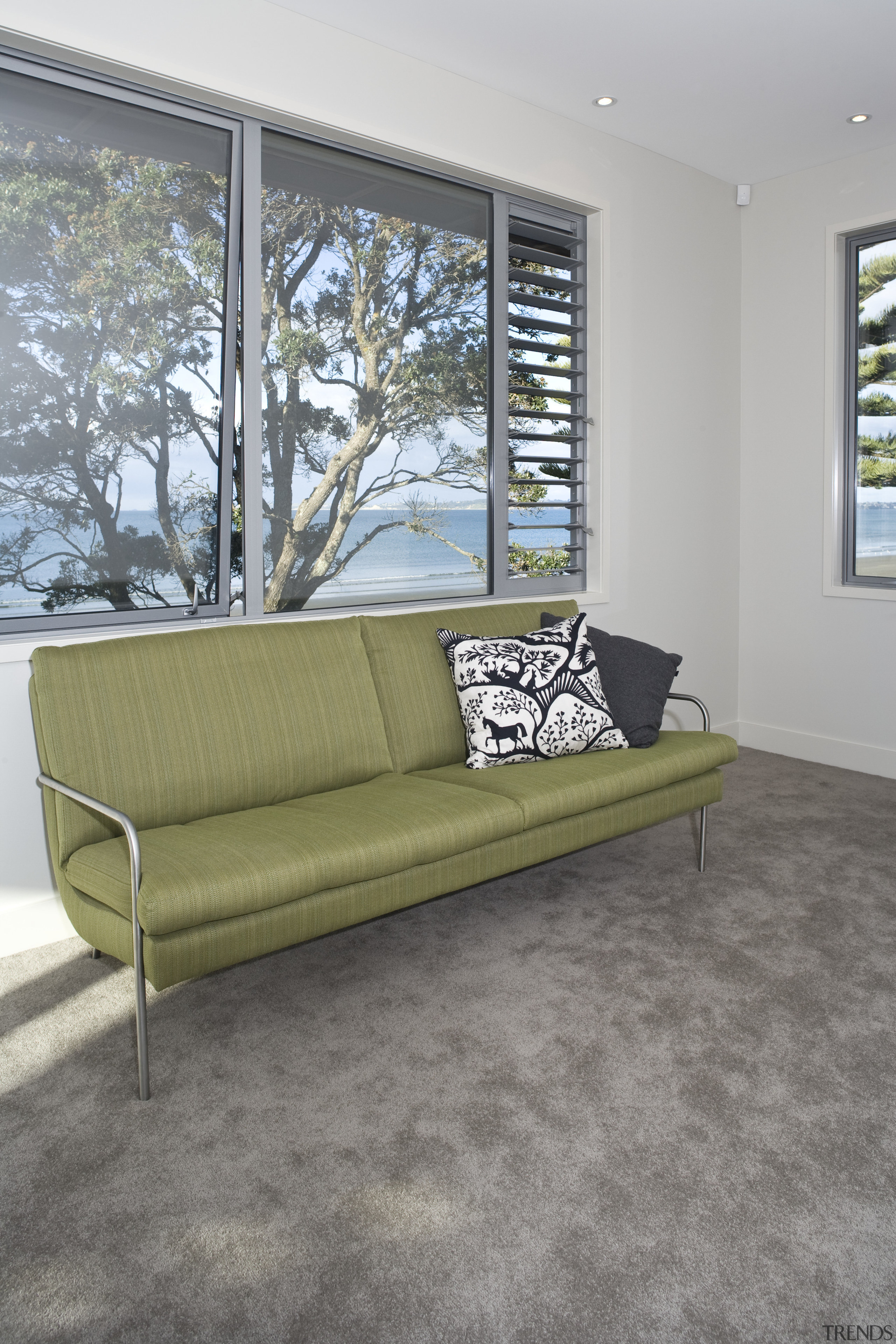 View of a living area at the Harbourcity couch, floor, flooring, furniture, home, interior design, living room, loveseat, sofa bed, table, wall, window, gray