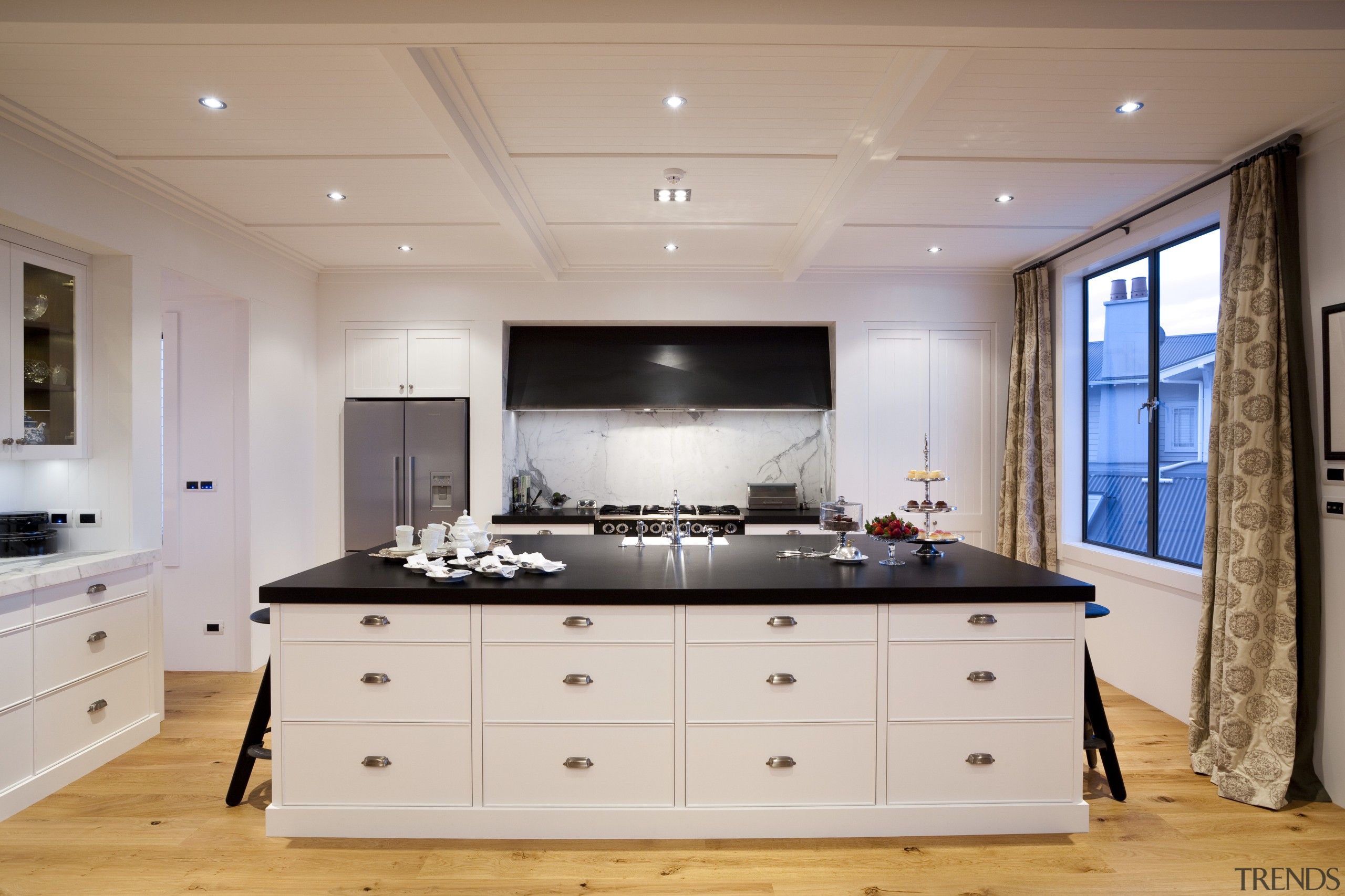 View of kitchen with wooden flooring, white cabinetry cabinetry, countertop, cuisine classique, floor, interior design, kitchen, room, gray