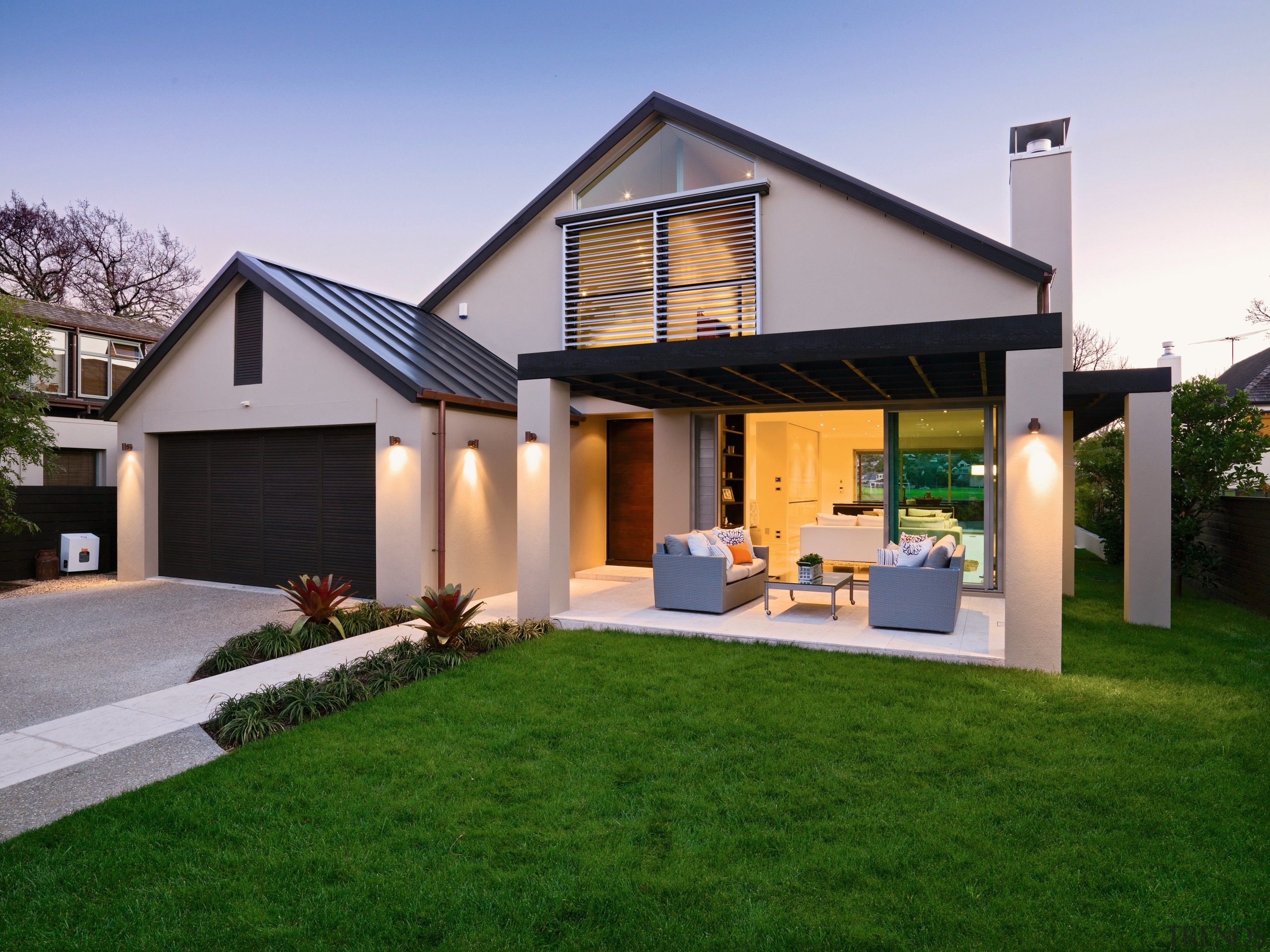 A view of a home custom built by backyard, cottage, elevation, estate, facade, home, house, property, real estate, residential area, roof, siding, villa, window, yard, green