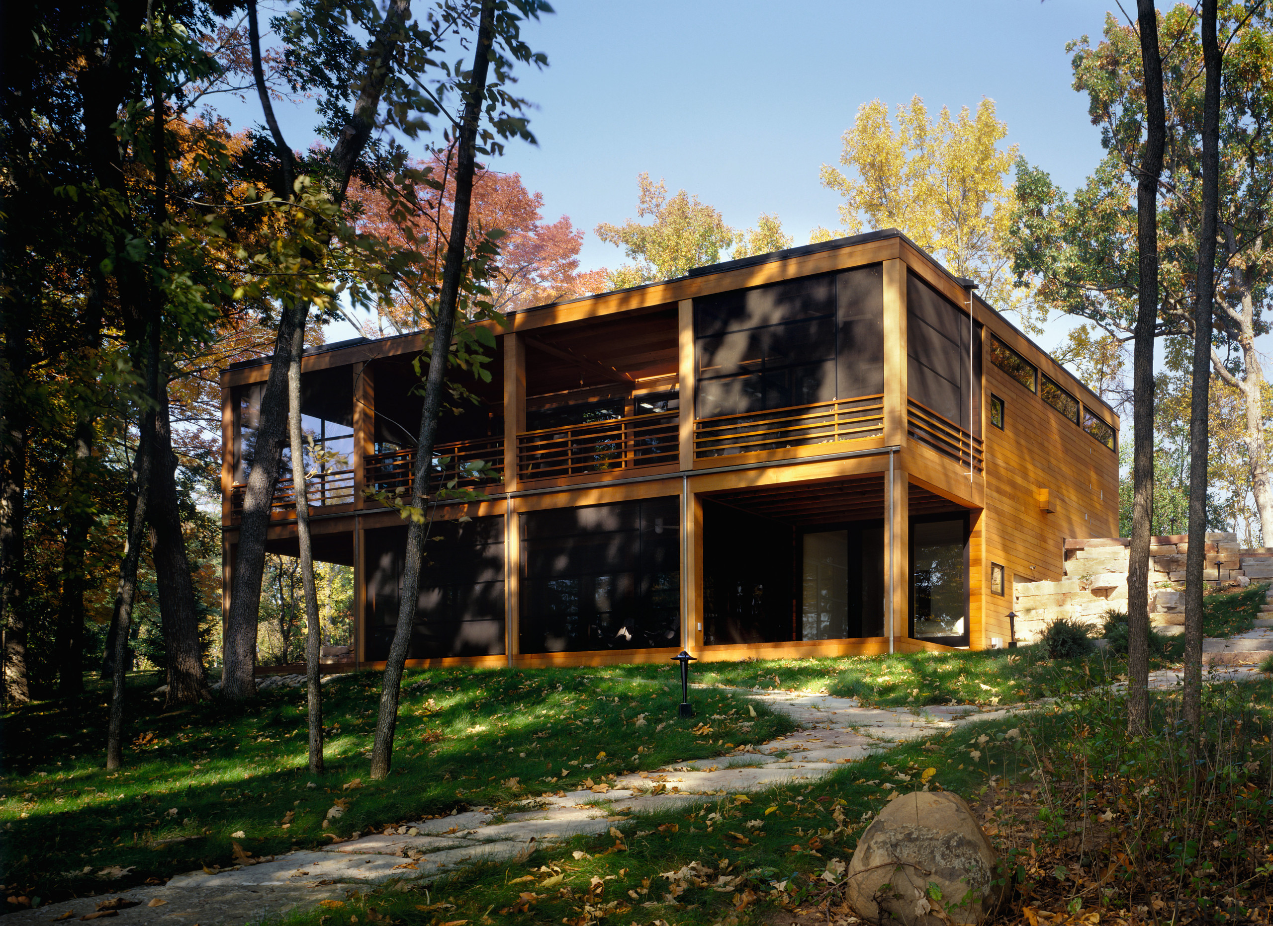 view of this holiday home featuring full height architecture, cottage, home, house, log cabin, plant, real estate, shack, tree, black, brown