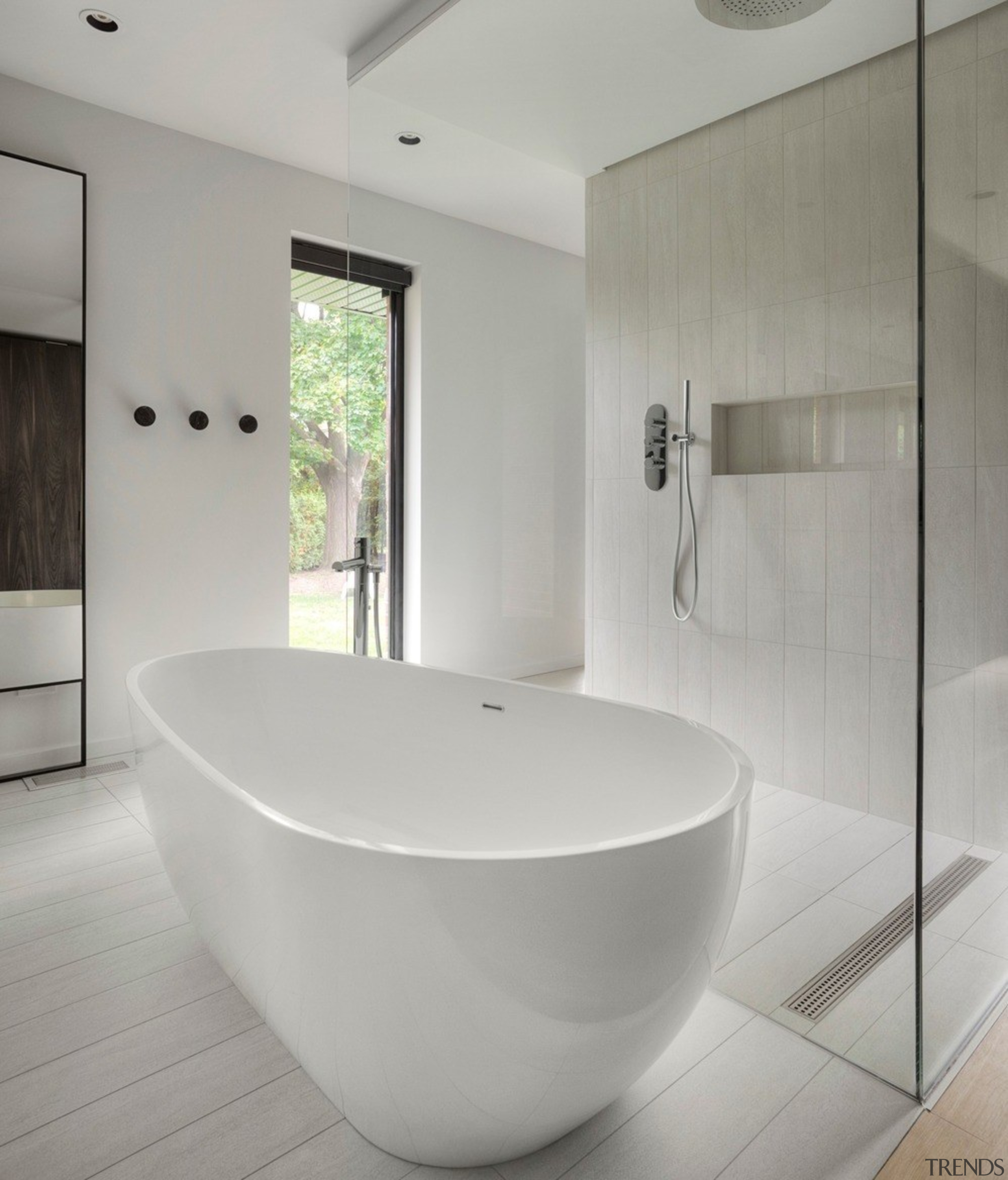 The freestanding bath tub in front of the architecture, bathroom, bathtub, building, ceiling, ceramic, floor, flooring, house, interior design, marble, material property, plumbing fixture, property, room, tap, tile, gray