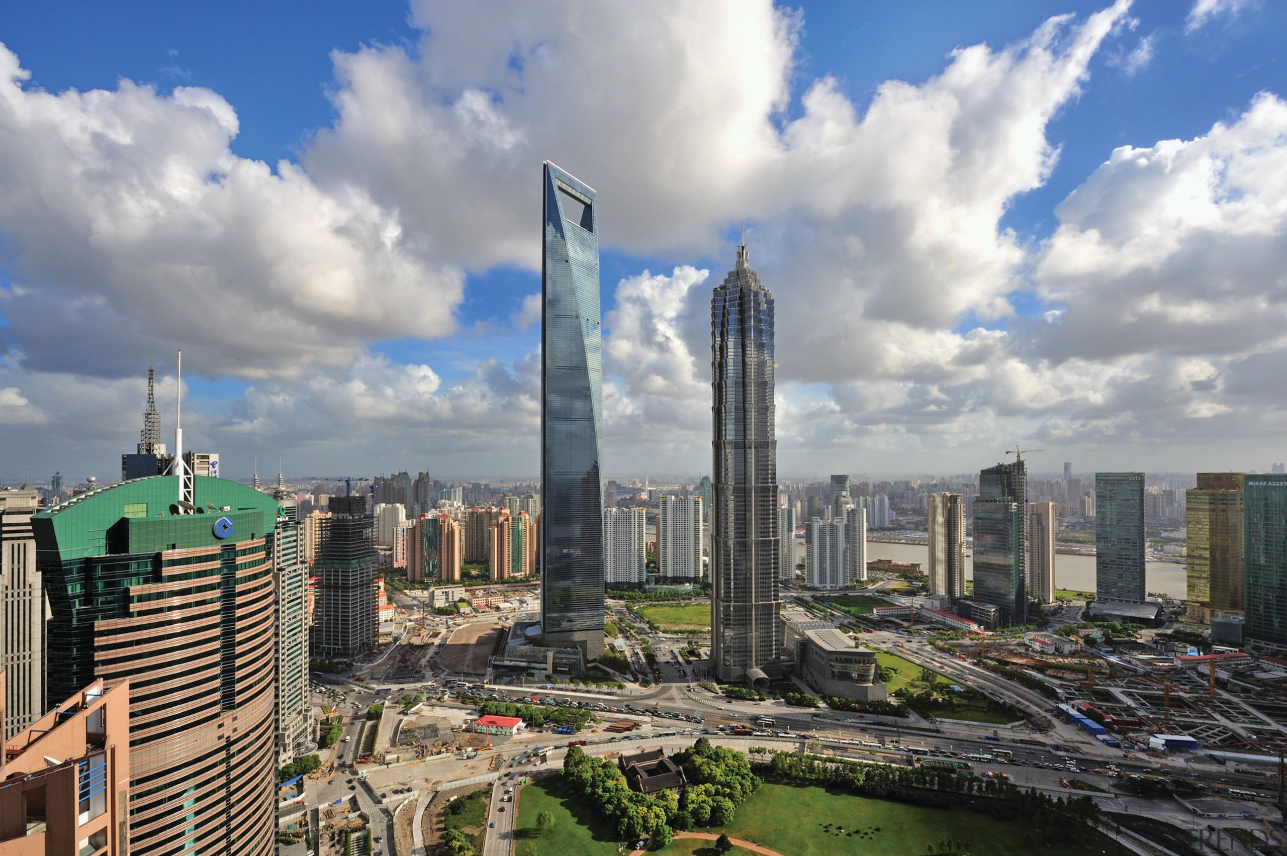 View of the Shanghai World Financial Centre in bird's eye view, building, city, cityscape, cloud, condominium, corporate headquarters, daytime, downtown, horizon, landmark, metropolis, metropolitan area, mixed use, sky, skyline, skyscraper, tower, tower block, urban area, gray