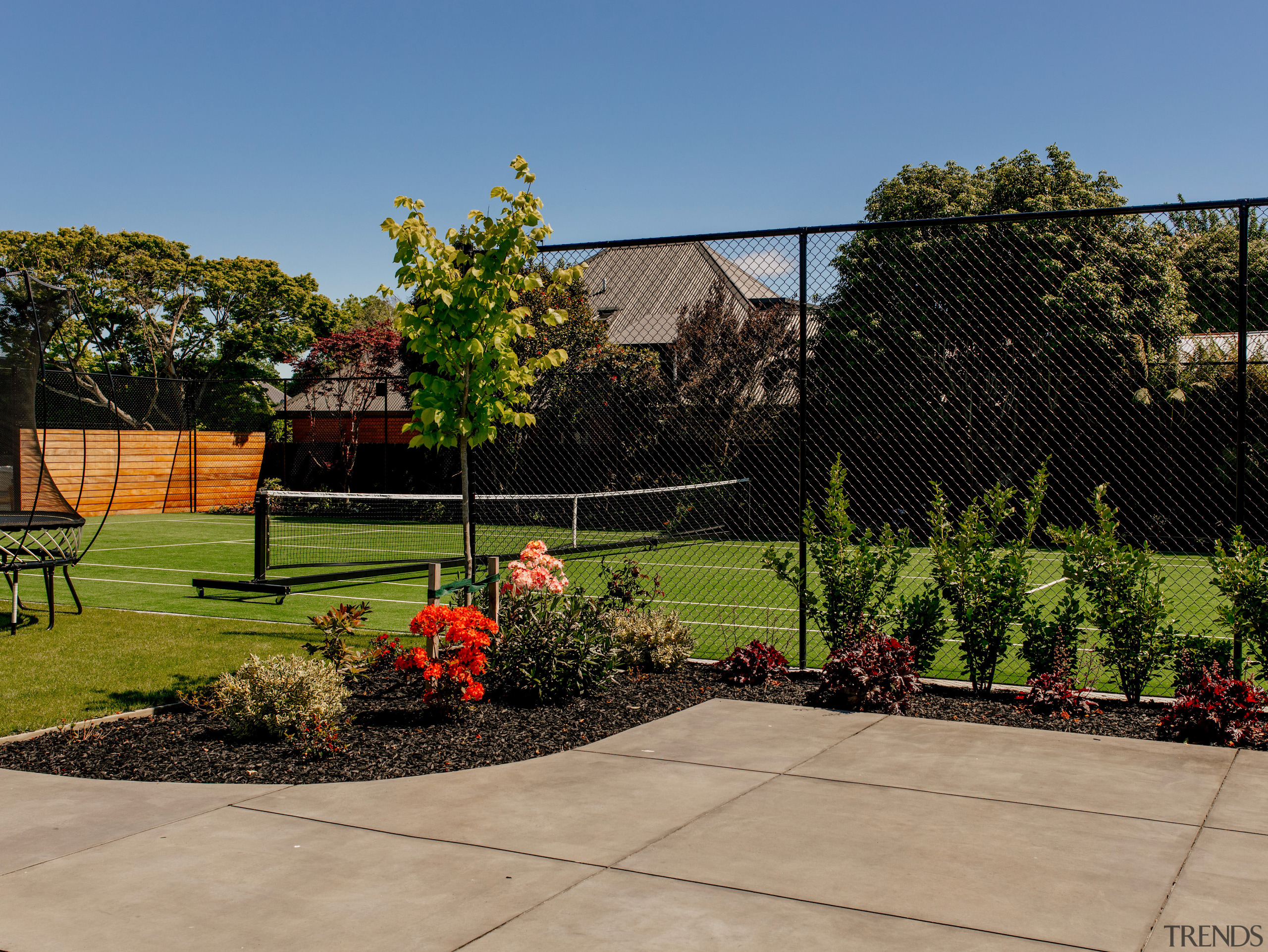 Xteriorscapes chose the tennis court's placement and orientation, 