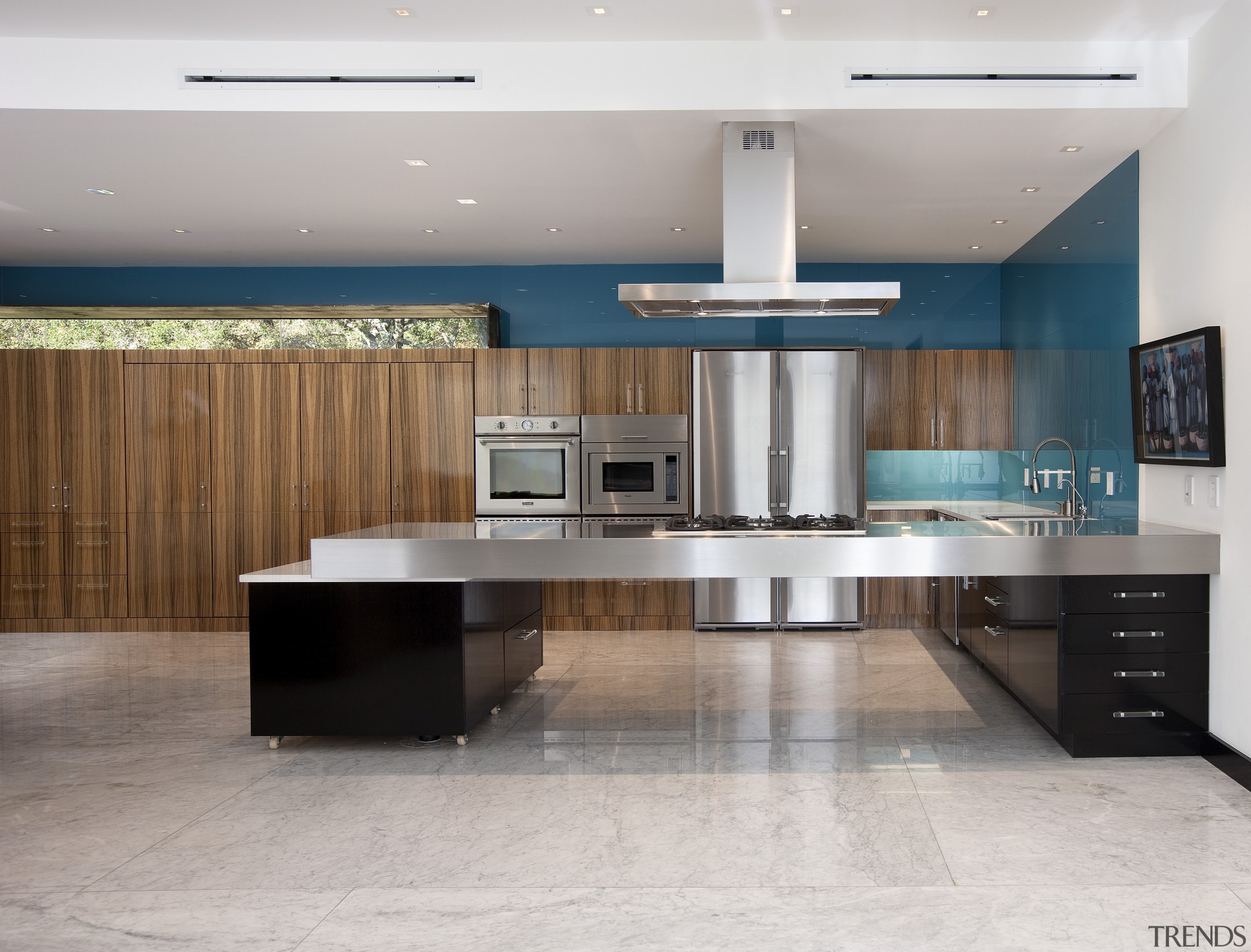 View of a minimalist kitchen which features floating cabinetry, countertop, floor, flooring, interior design, kitchen, gray