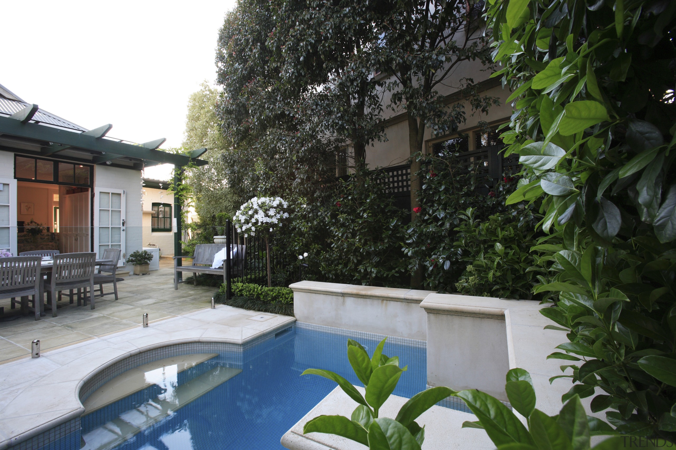 An exterior view of the pool and patio backyard, courtyard, estate, home, house, outdoor structure, plant, property, real estate, resort, tree, villa, yard, green