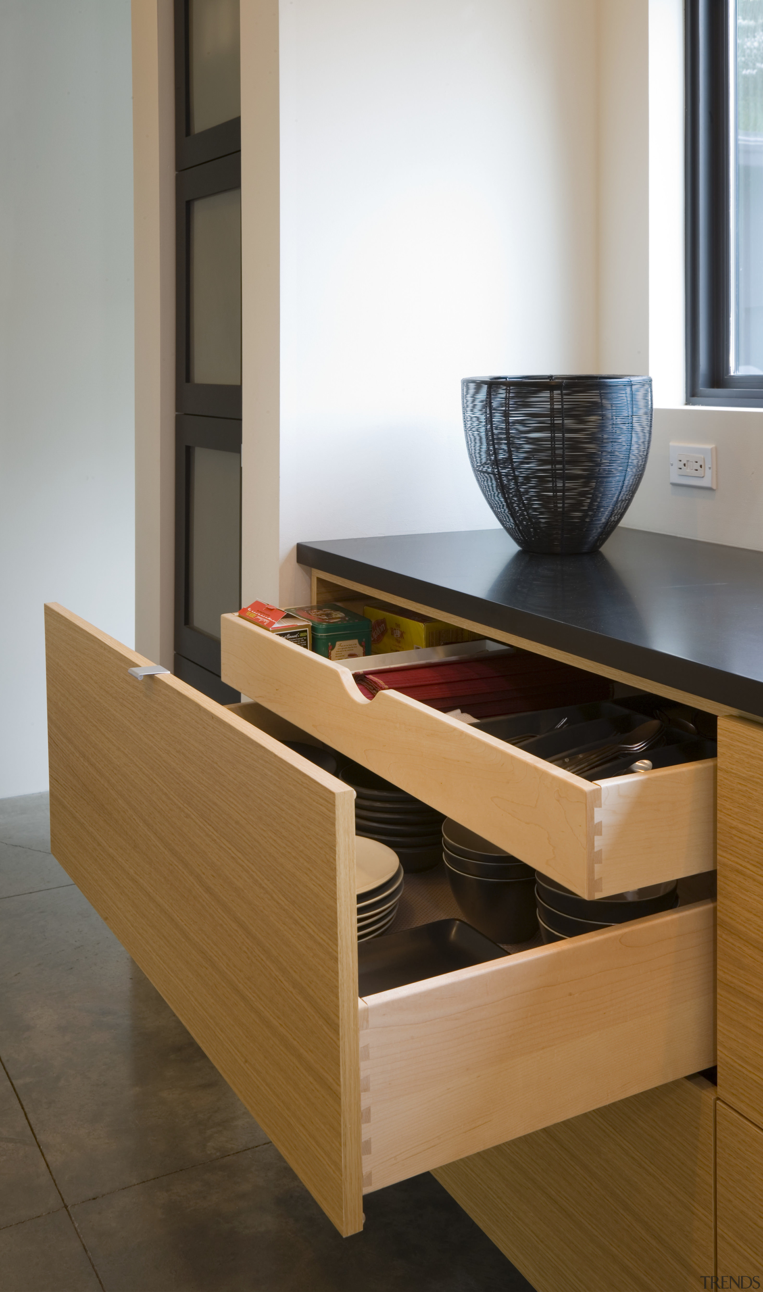 Kitchen designer Ashley Cole reduced the need for chest of drawers, coffee table, desk, drawer, floor, furniture, interior design, product design, sideboard, table, wood, brown, white