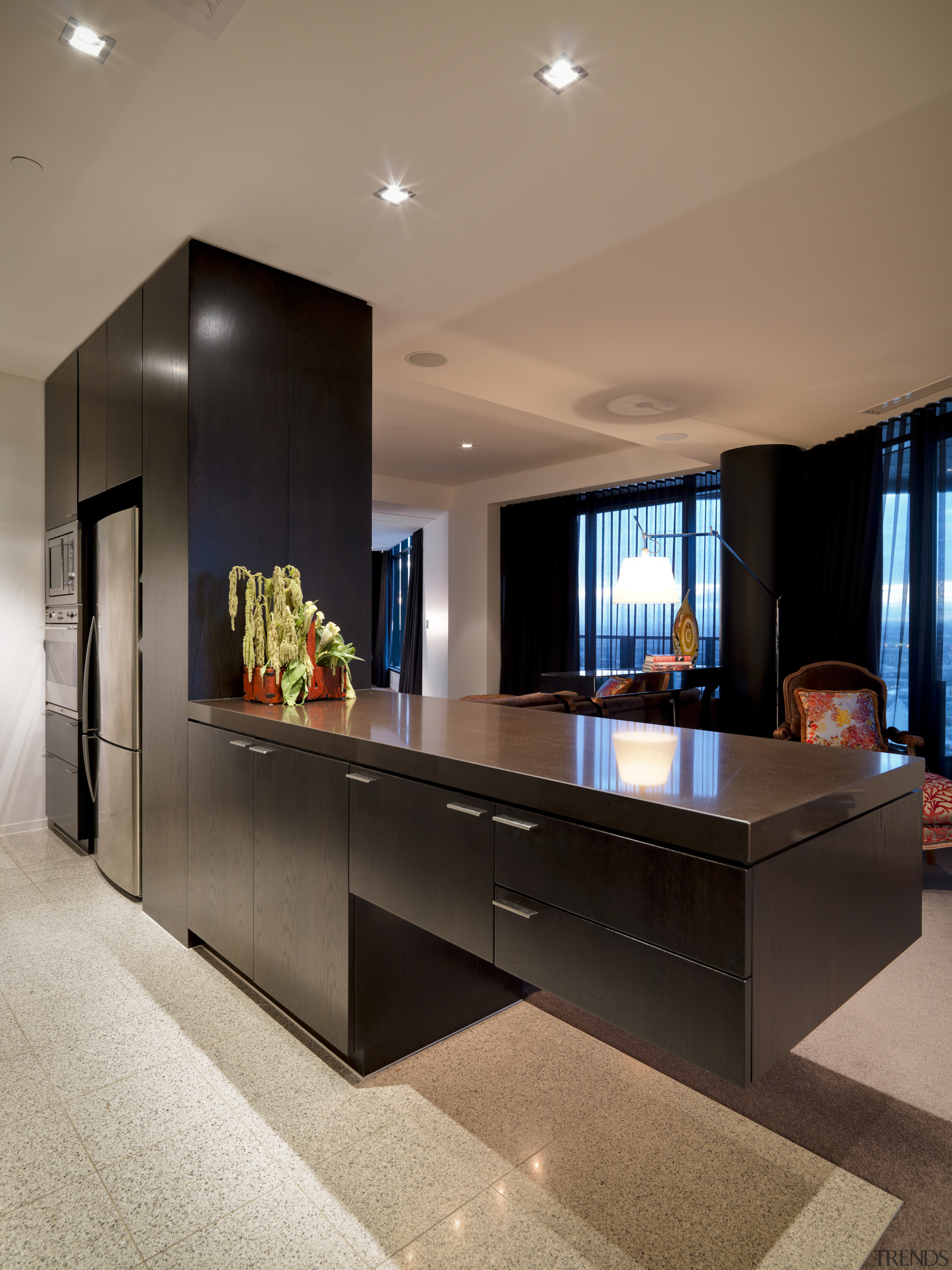 View of the kitchen where the island extends furniture, interior design, living room, table, brown, black