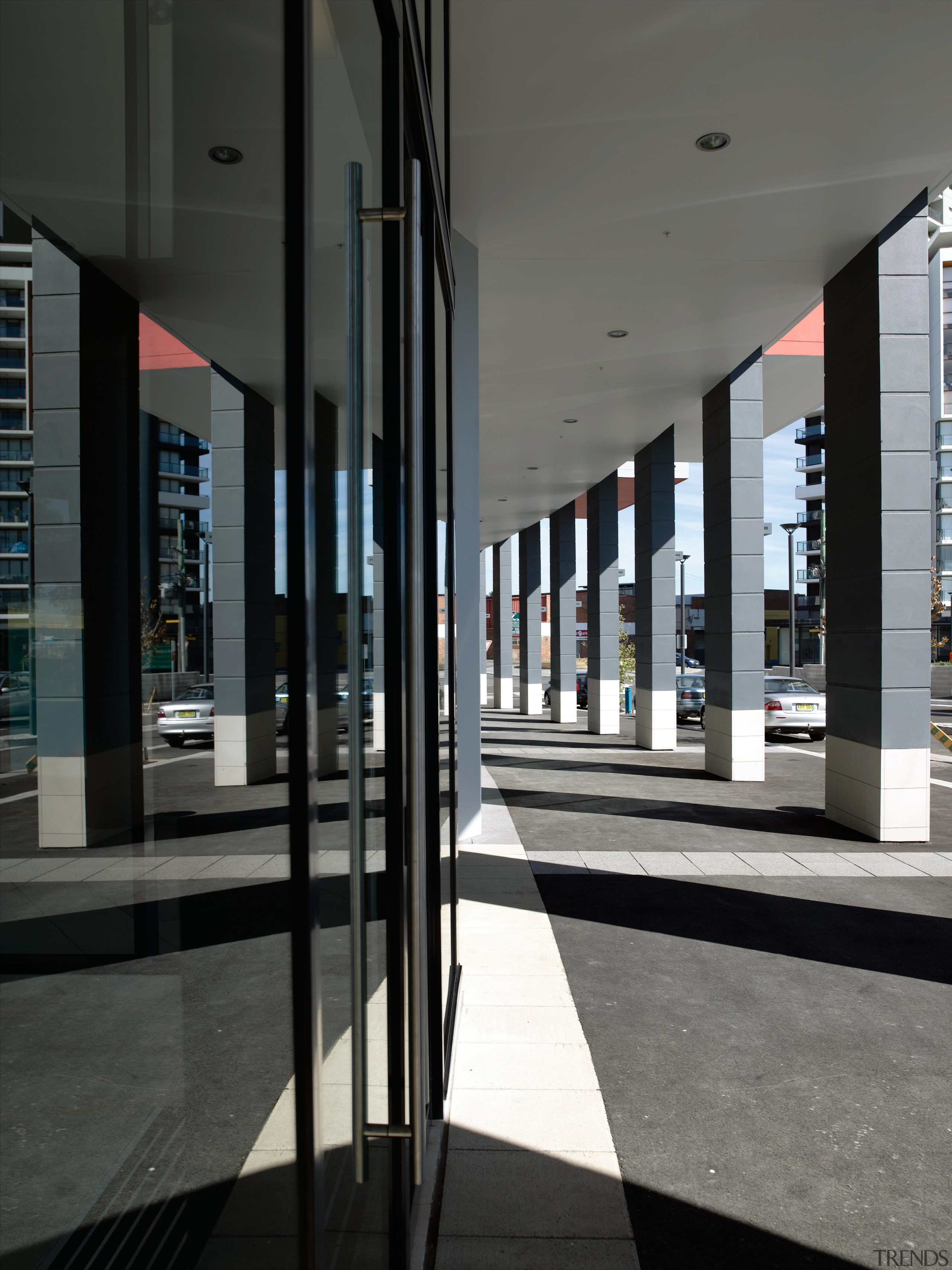 A view of this builidng corridor featuring  architecture, building, glass, metropolitan area, structure, window, black, gray