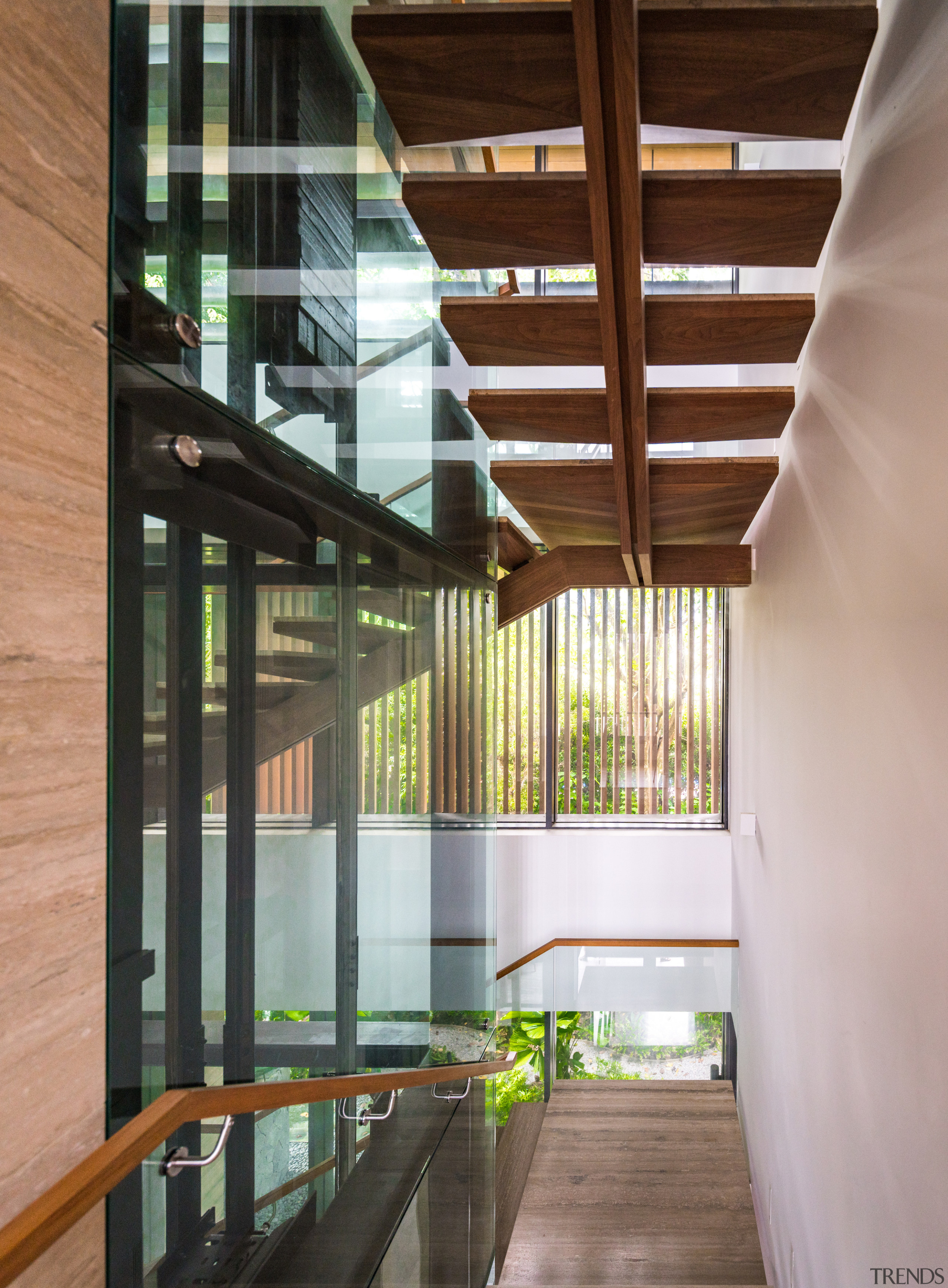Riserless, timber-tread stairs lead up to the master 