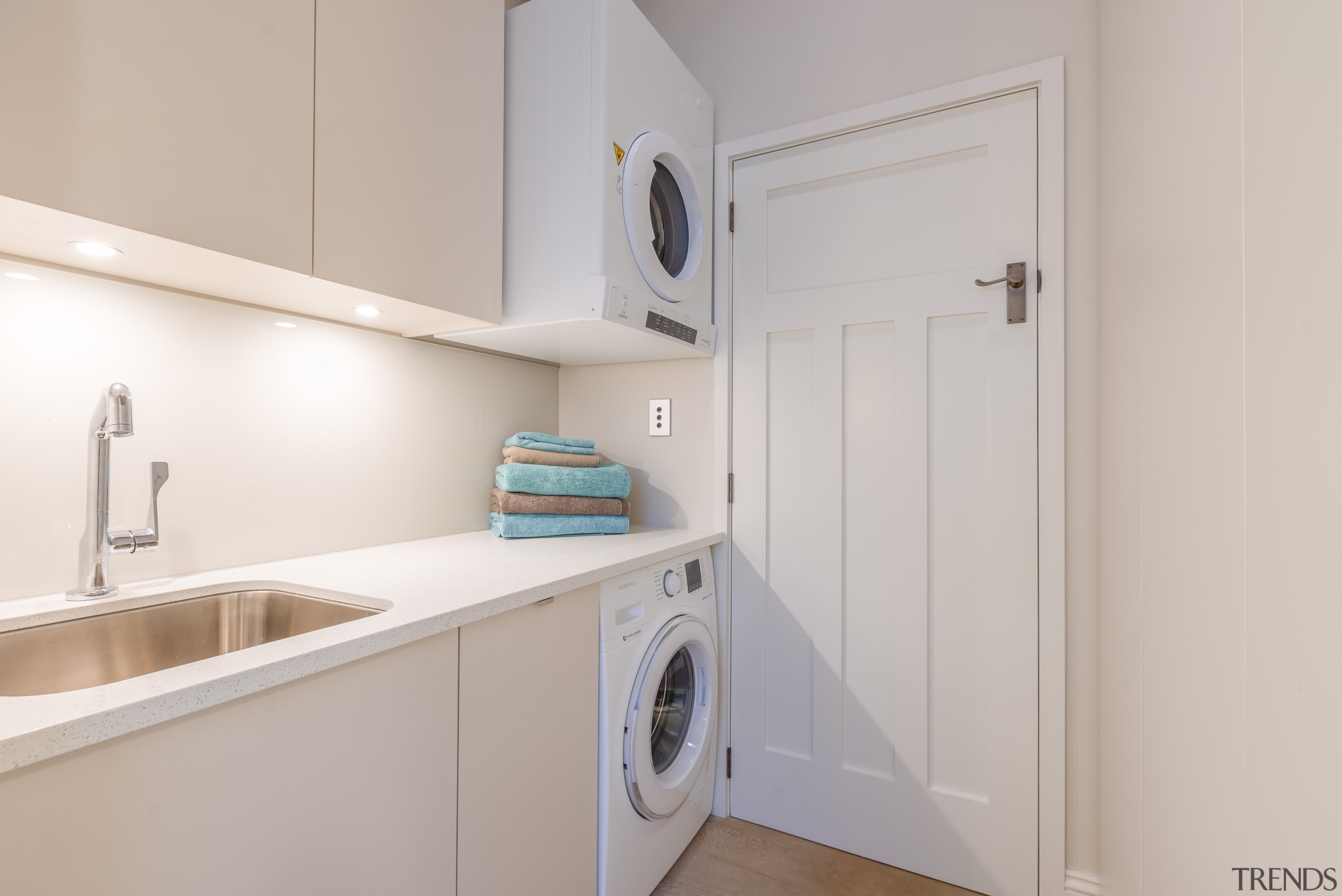 The washer and wall-mounted dryer in this laundry clothes dryer, home appliance, kitchen, laundry, laundry room, major appliance, property, real estate, room, washing machine, gray