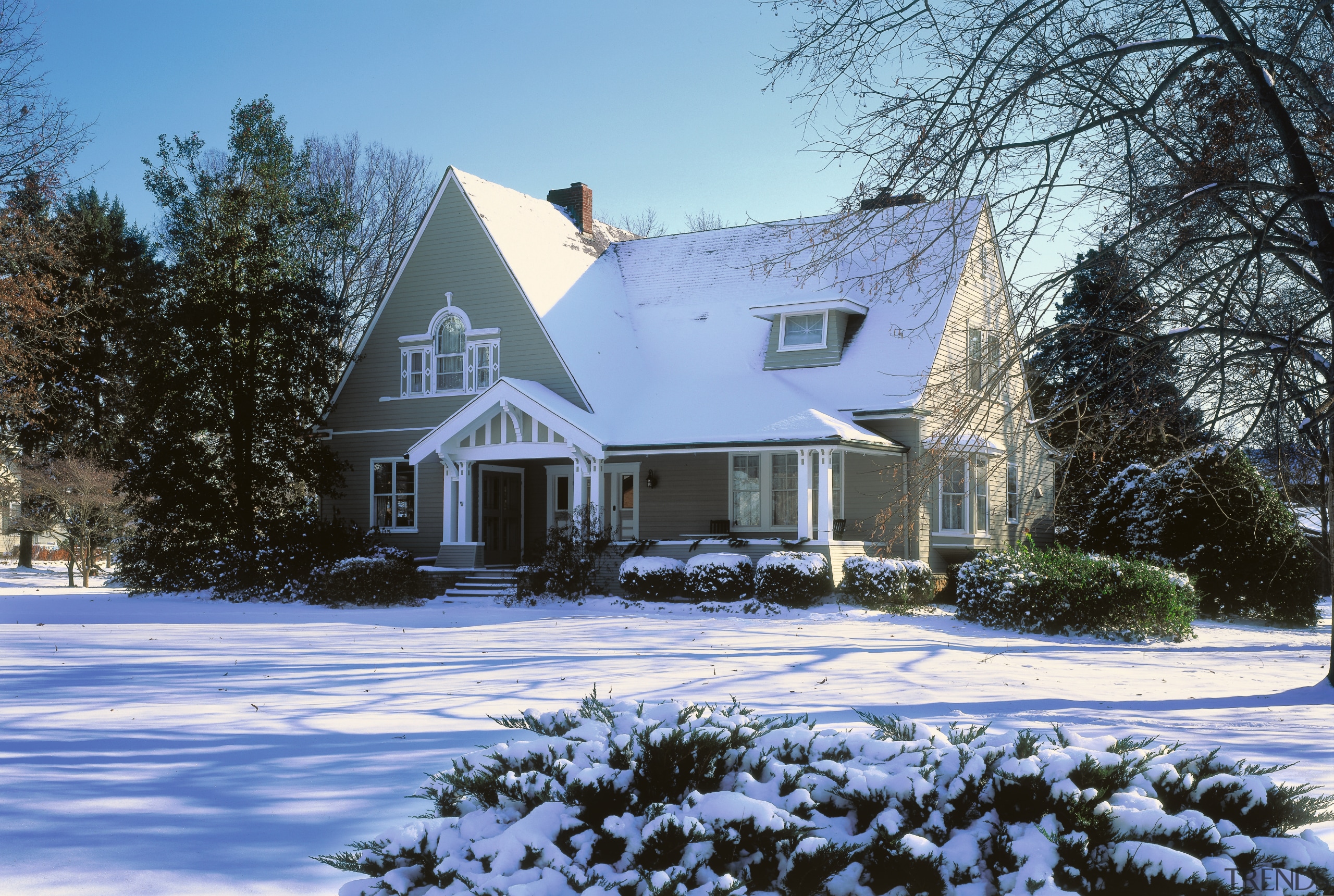 This century old home was remodelled  using building, cottage, estate, facade, farmhouse, freezing, home, house, log cabin, mansion, neighbourhood, property, real estate, residential area, siding, snow, suburb, tree, winter, teal, black