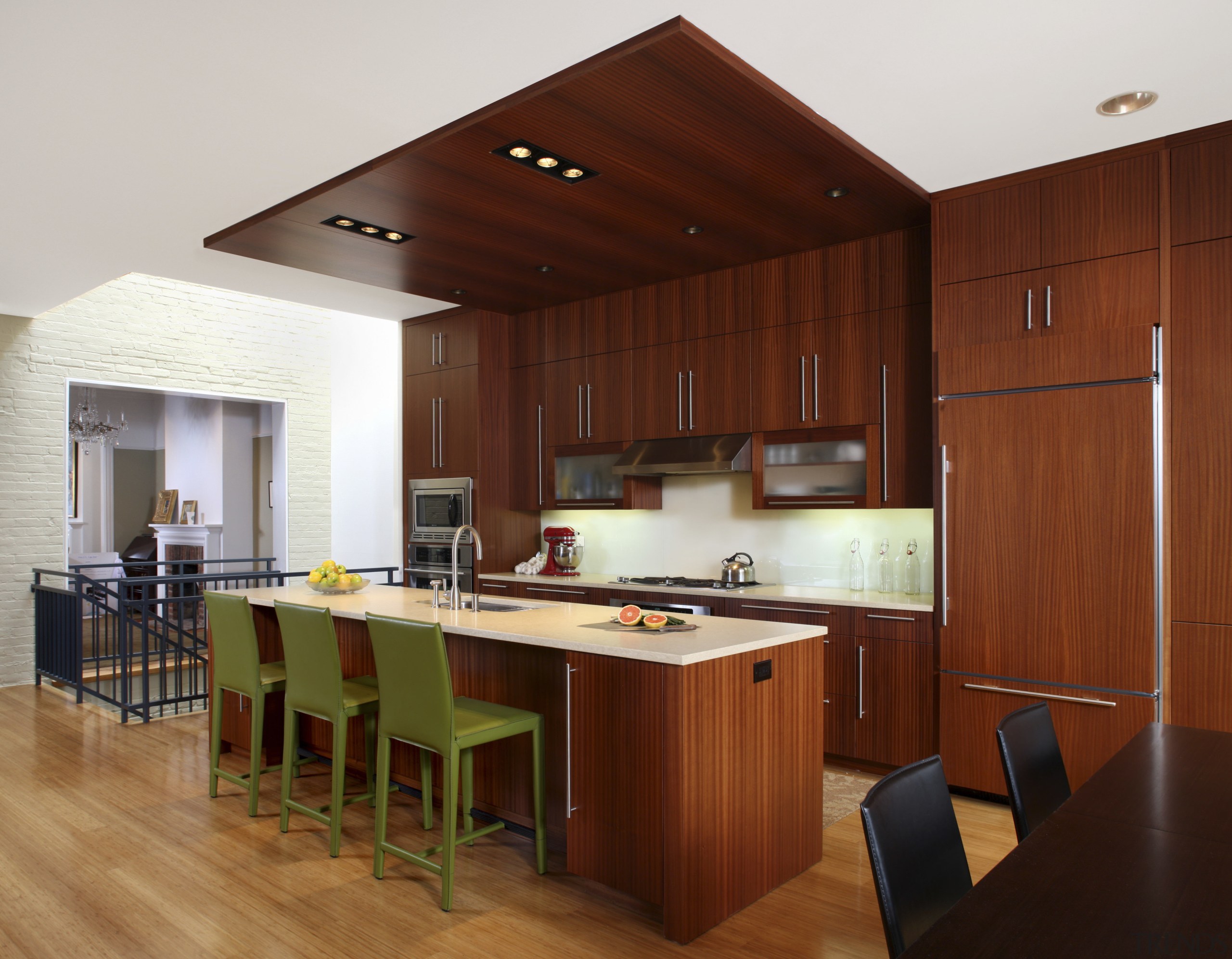 View of a kitchen which features a kitchen cabinetry, ceiling, countertop, cuisine classique, floor, flooring, hardwood, interior design, kitchen, real estate, room, table, wood, wood flooring, brown, white