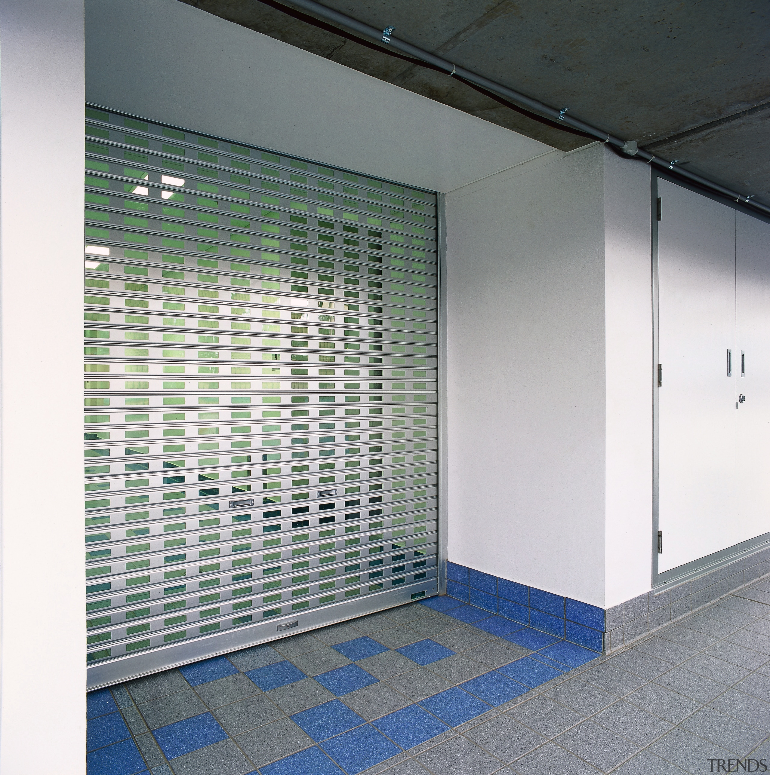 View of slotted aluminium roller shutter door. - architecture, daylighting, glass, wall, gray, white