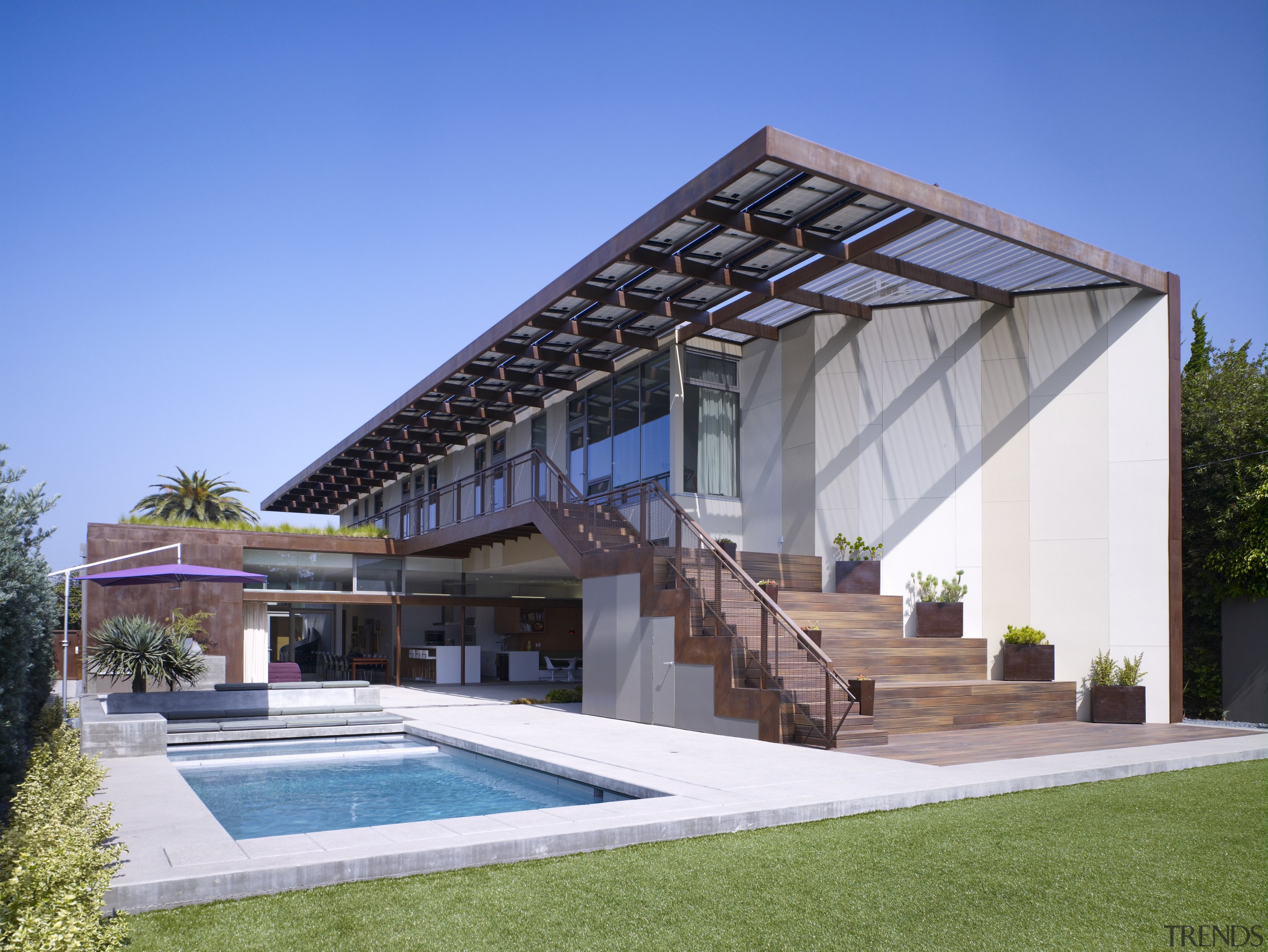 The expansive outdoor space in this home is architecture, backyard, estate, facade, home, house, property, real estate, roof, swimming pool, villa, teal